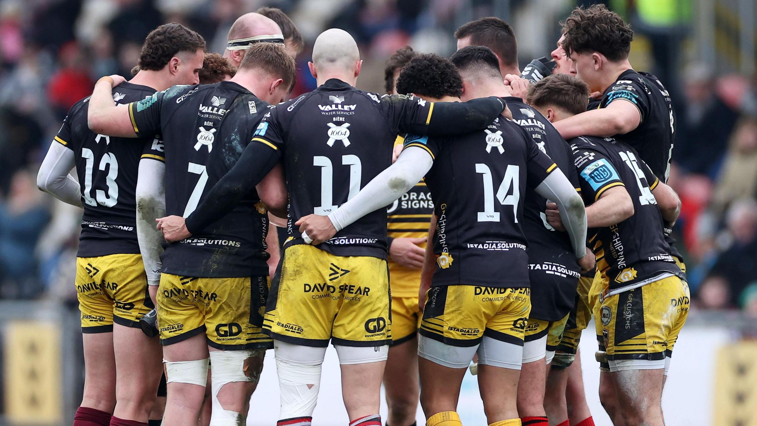 Dragons players in a huddle