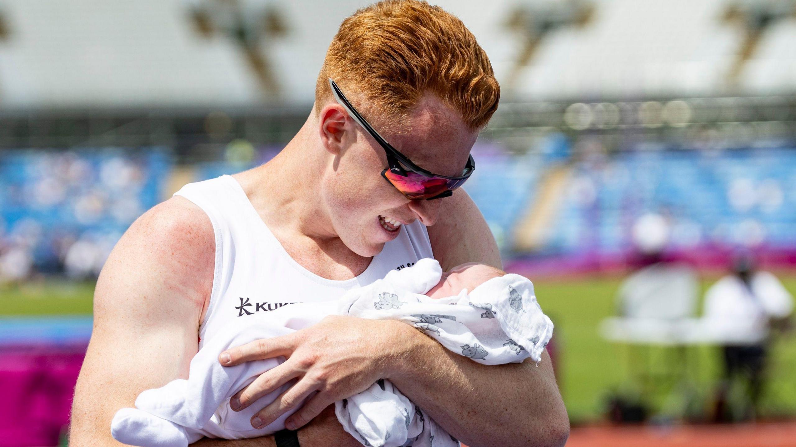 Alastair Chalmers cradles baby son Robert after winning British 400m hurdles title