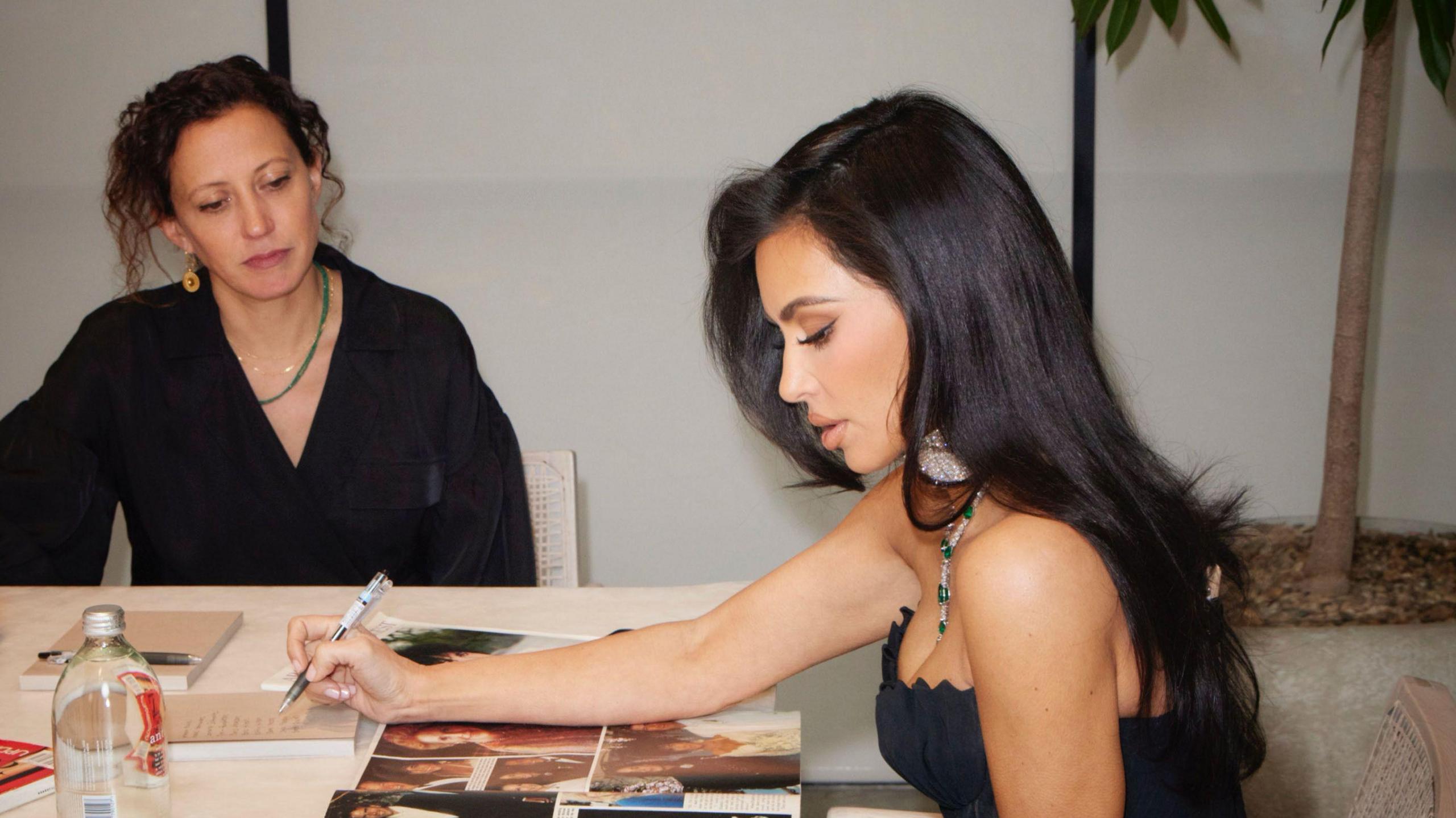 Kim Kardashian looking through photos of Elizabeth Taylor