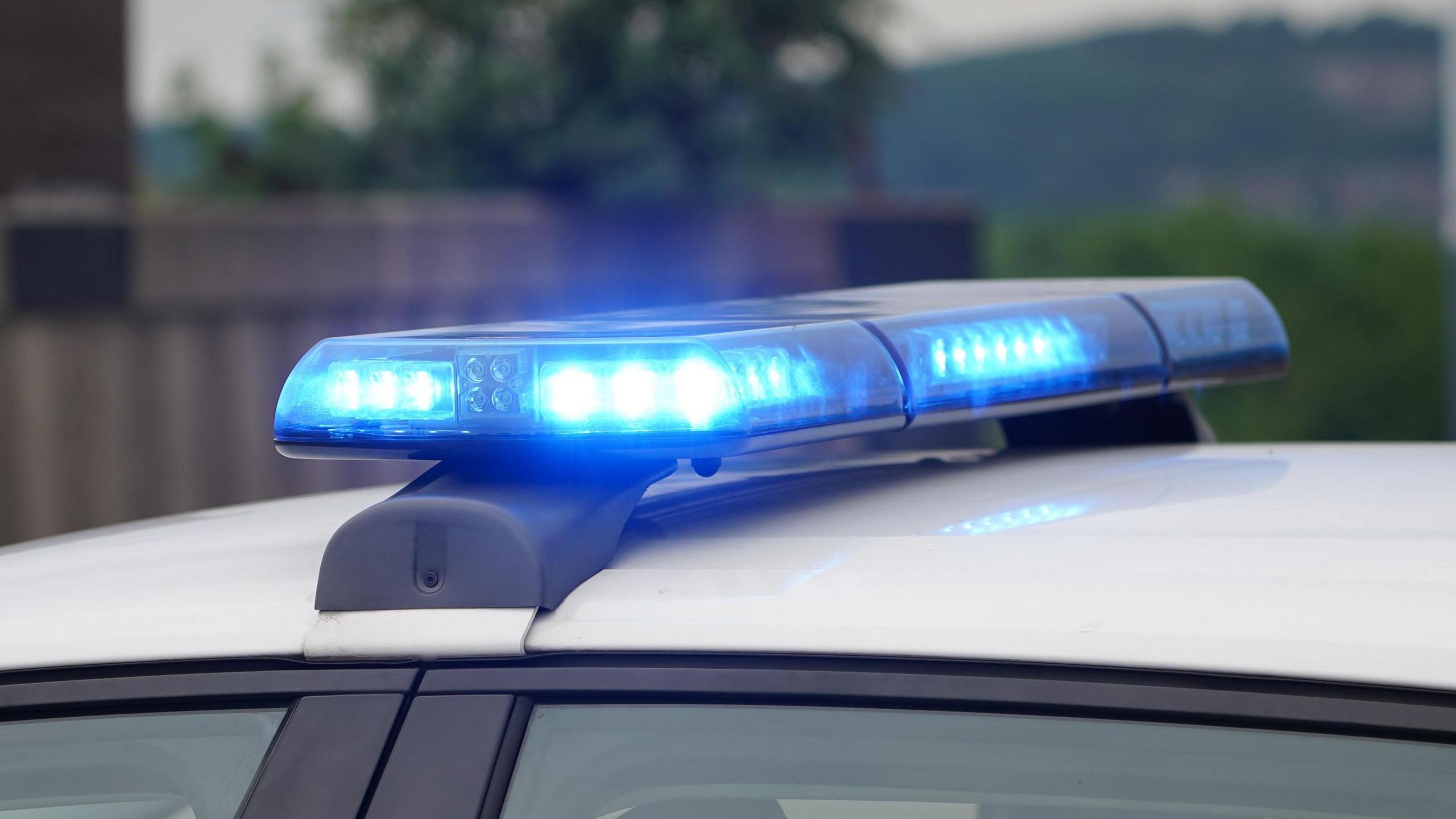 A general generic stock image of blue lights on a police car