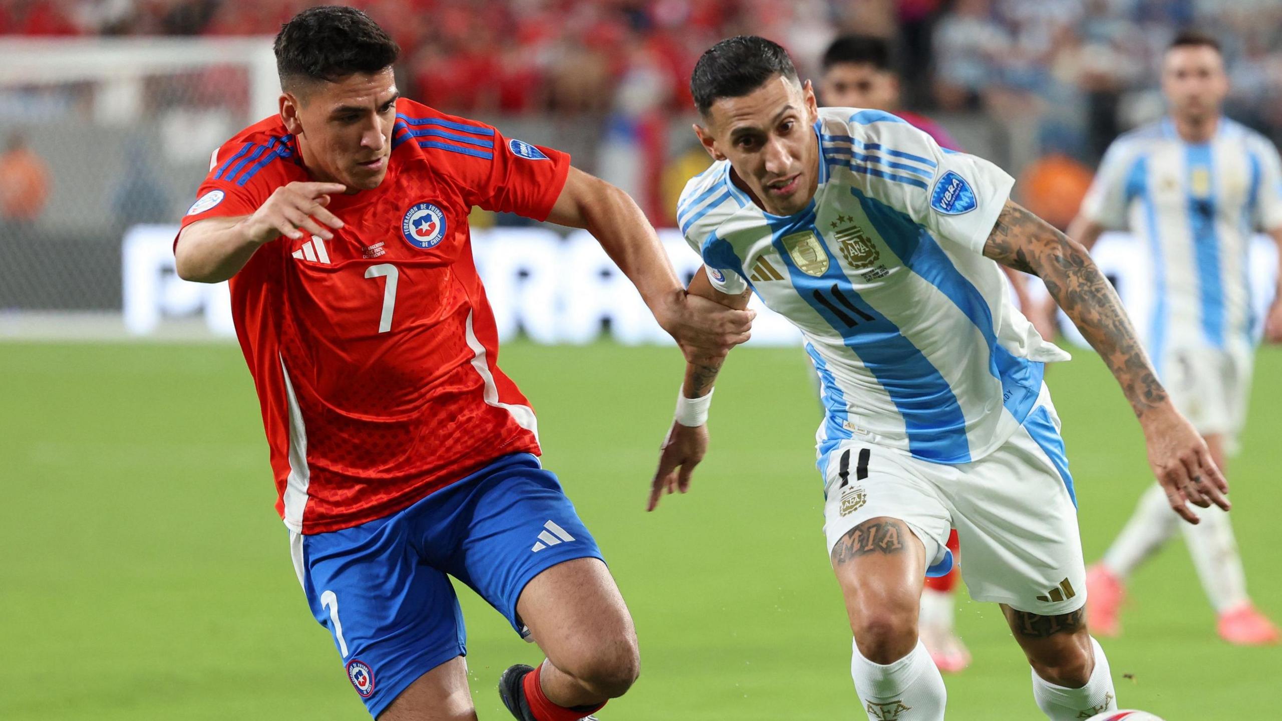 Marcelino Nunez takes on Argentina's Angel Di Maria