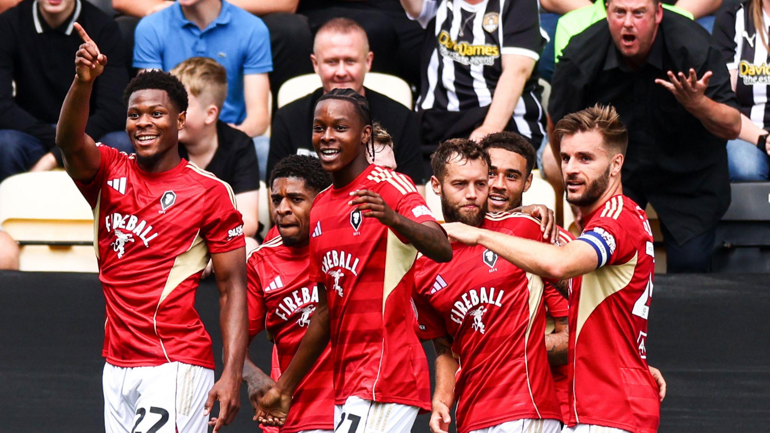 Salford City players celebrate scoring against Notts County