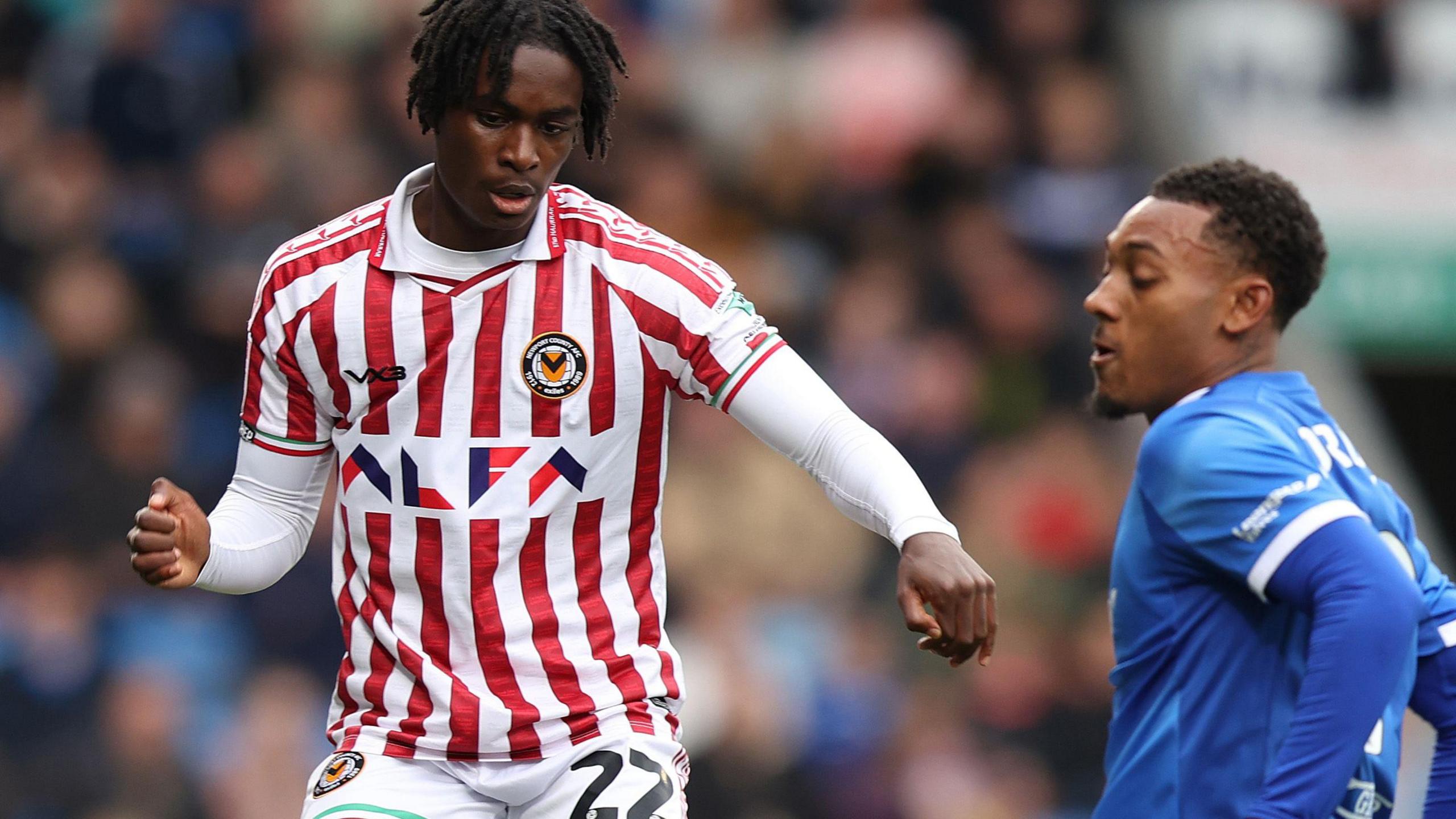 Habeeb Ogunneye of Newport in action against Lewis Gordon of Chesterfield