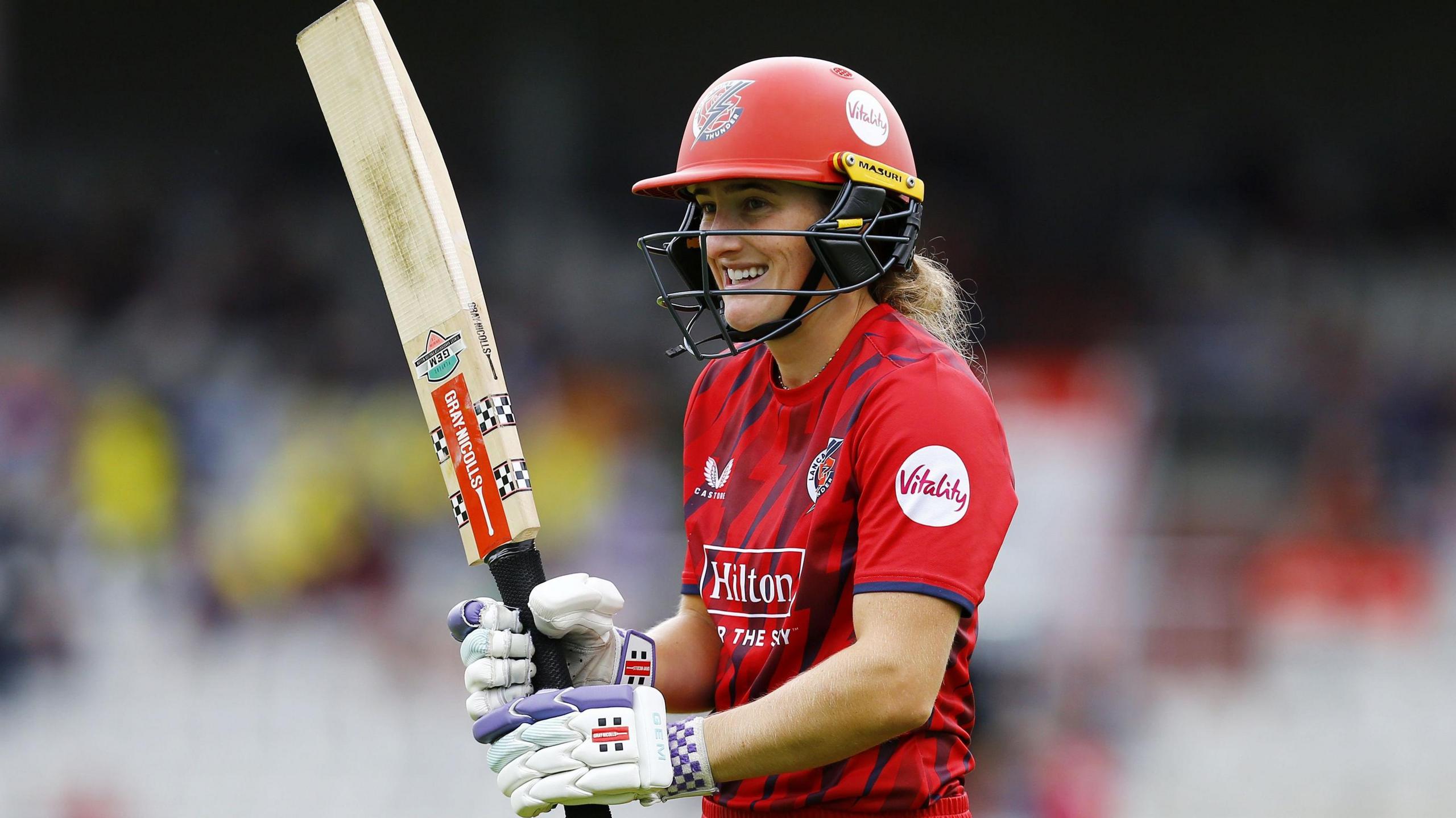 Emma Lamb holding her bat at a perpendicular angle during an innings for Lancashire Thunder