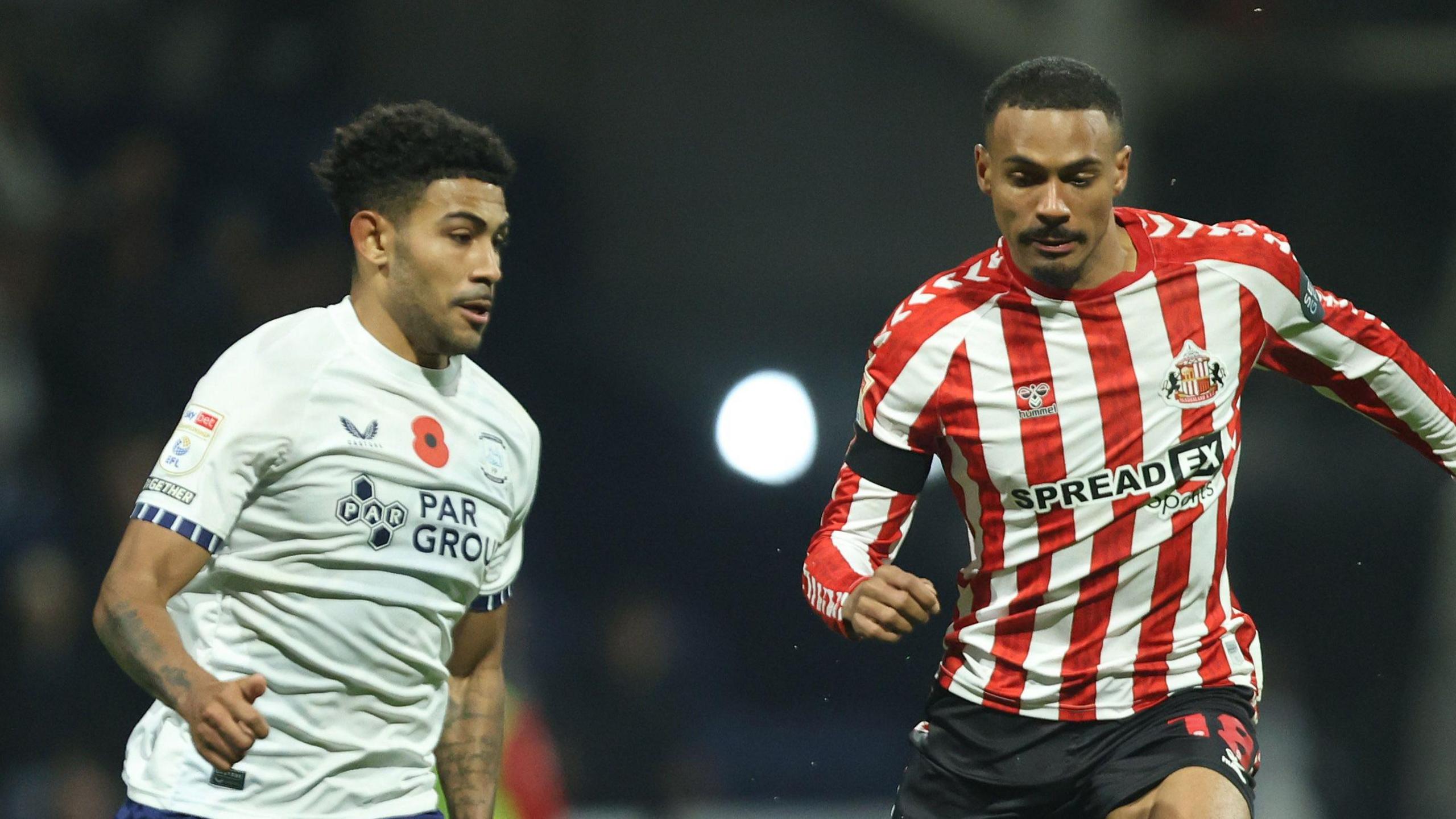 Kaine Kesler-Hayden of Preston battles for the ball with Sunderland's Wilson Isidor