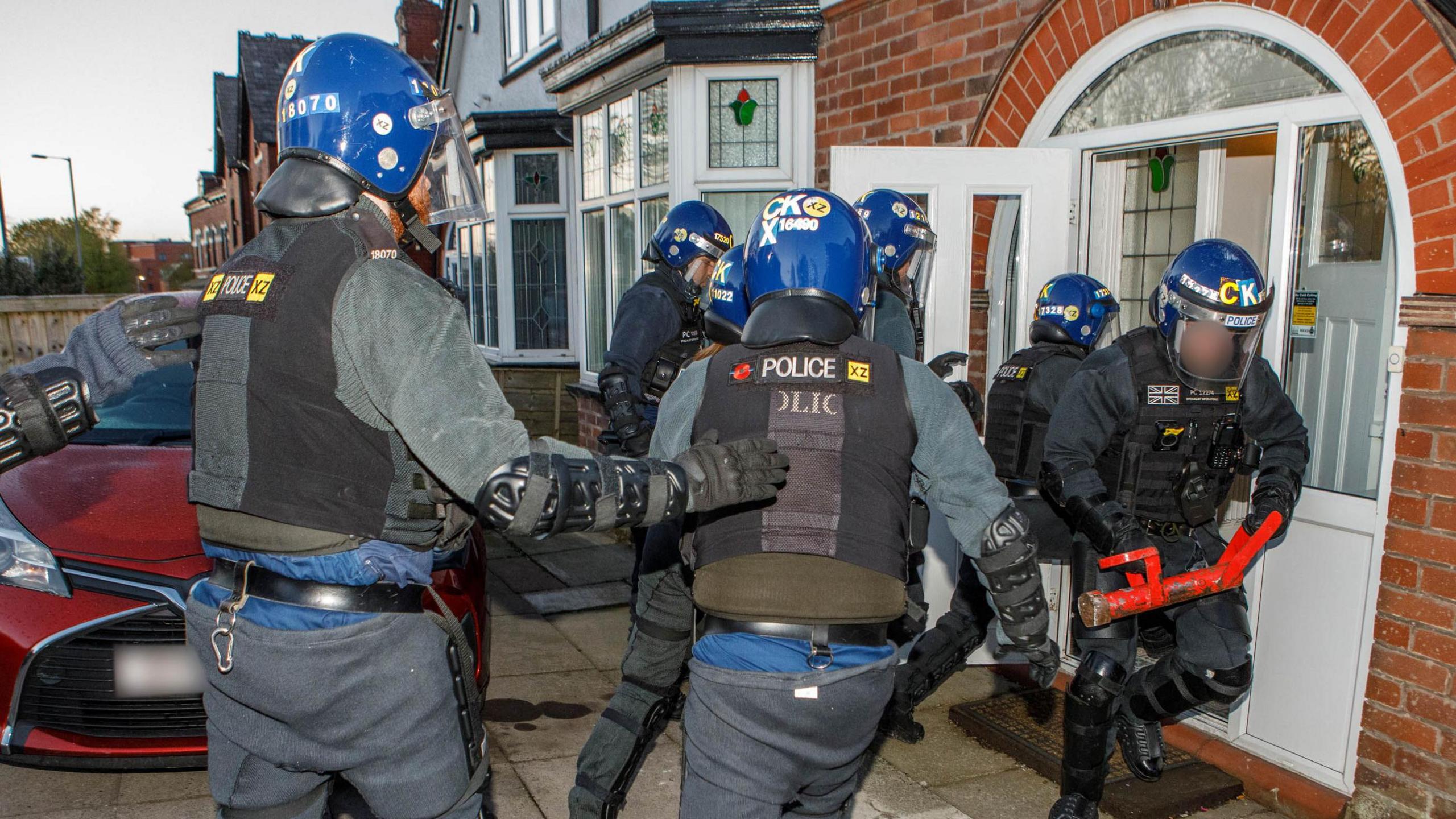 Police raiding a Rochdale home