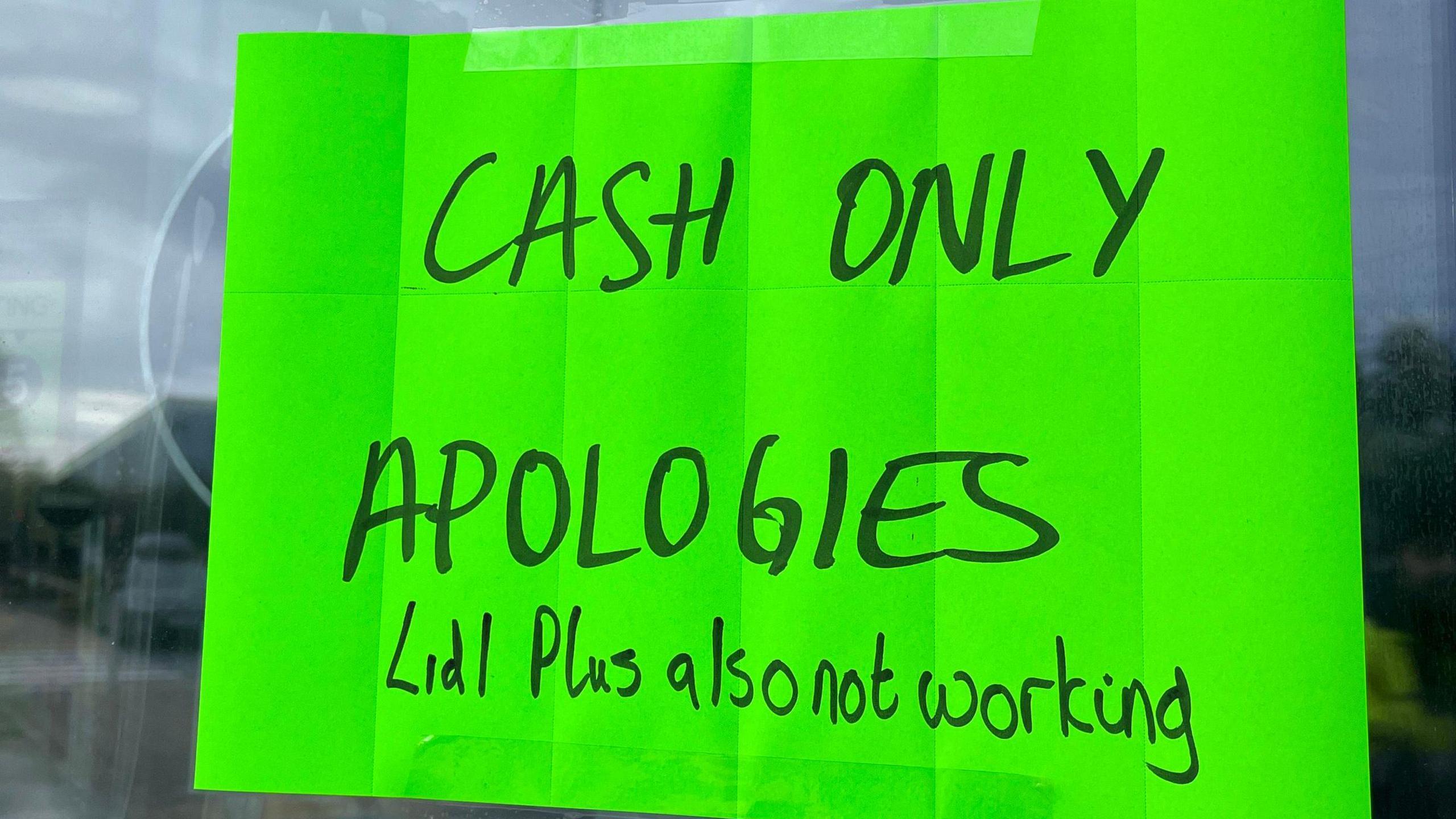 A "cash only" sign in the window of a Lidl store in Bingham