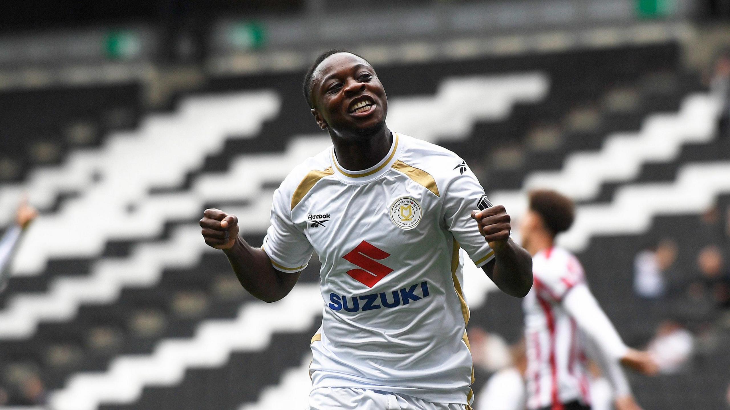 Aaron Nemane celebrates scoring MK Dons' fifth goal against Cheltenham