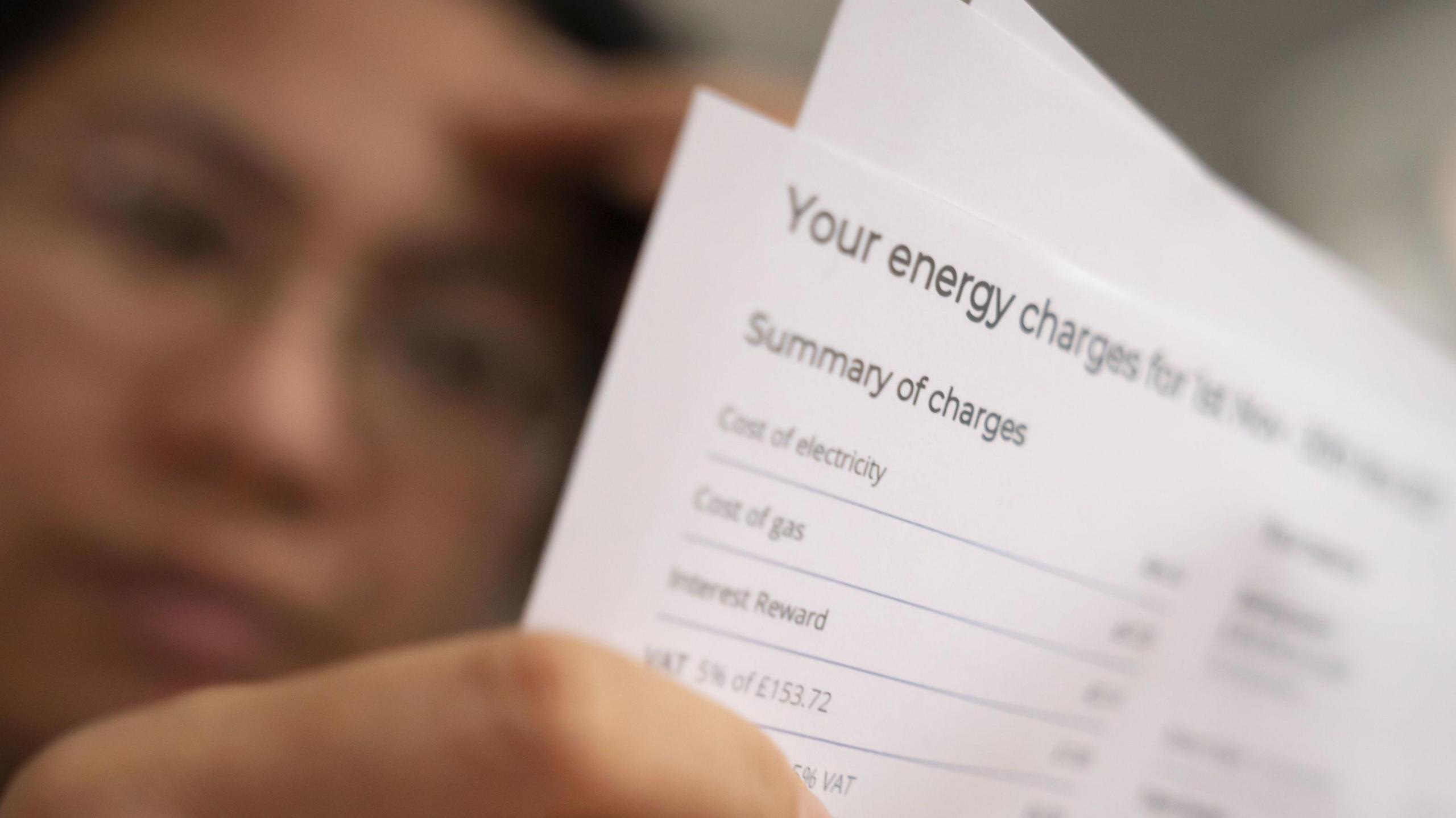 File photo dated of a person holding an energy bill.