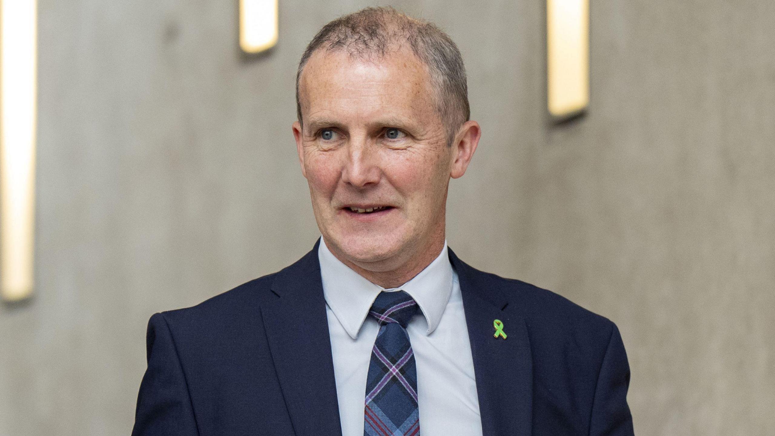 Michael Matheson in a blue suit at Holyrood