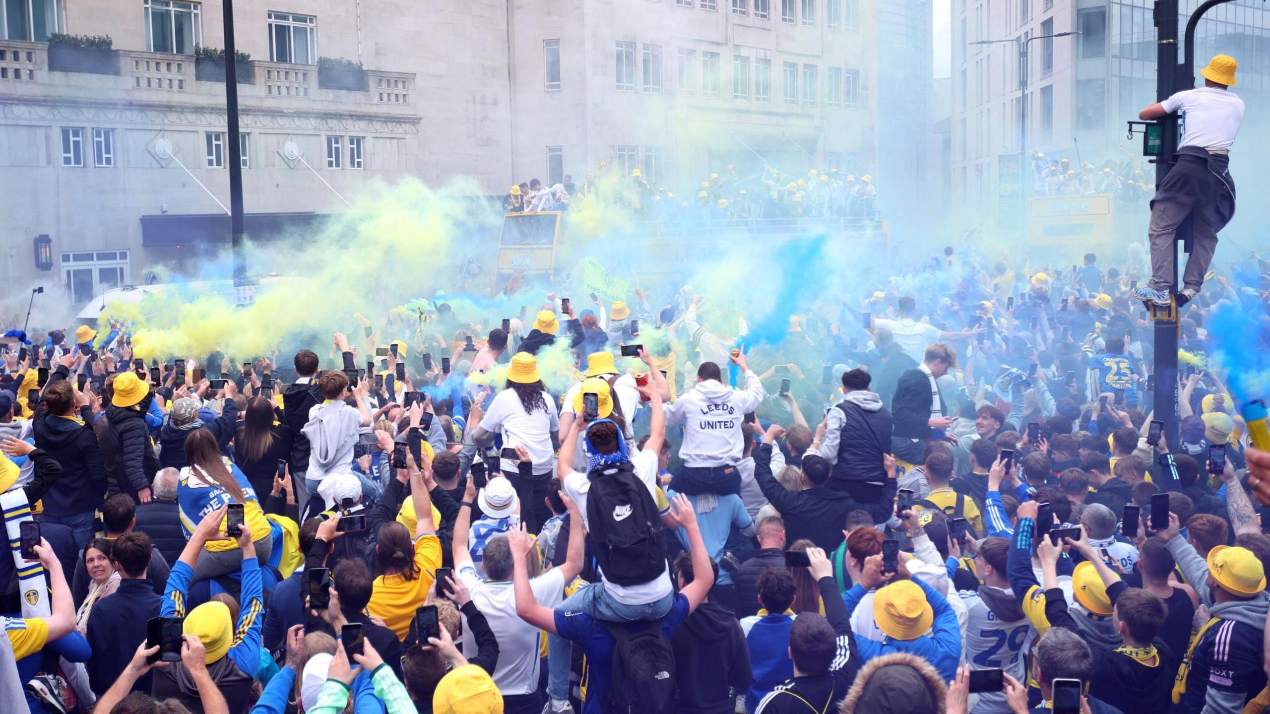 Flares go off in the air as fans cheer