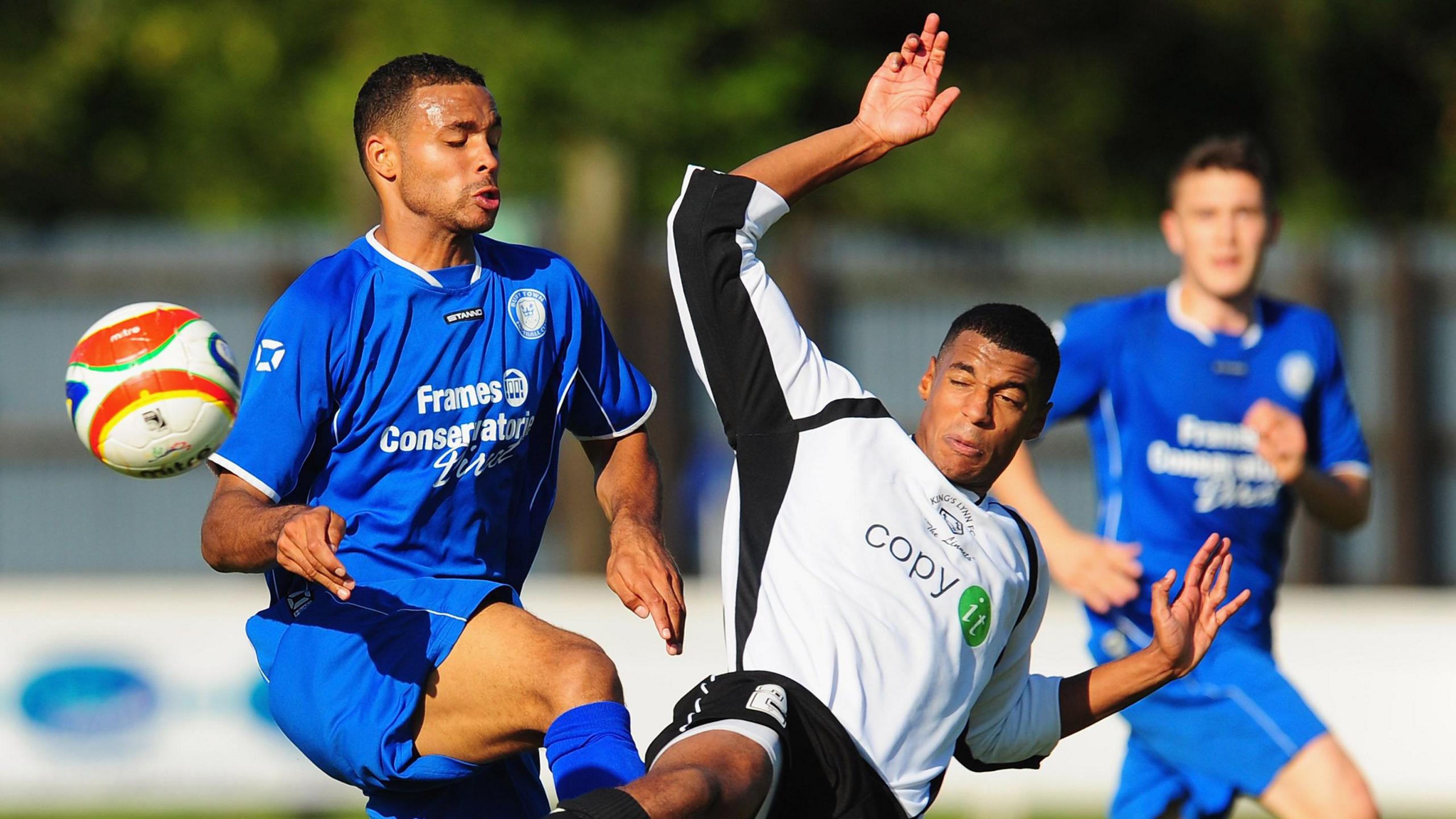 Two footballers competing for the ball during an FA Cup game