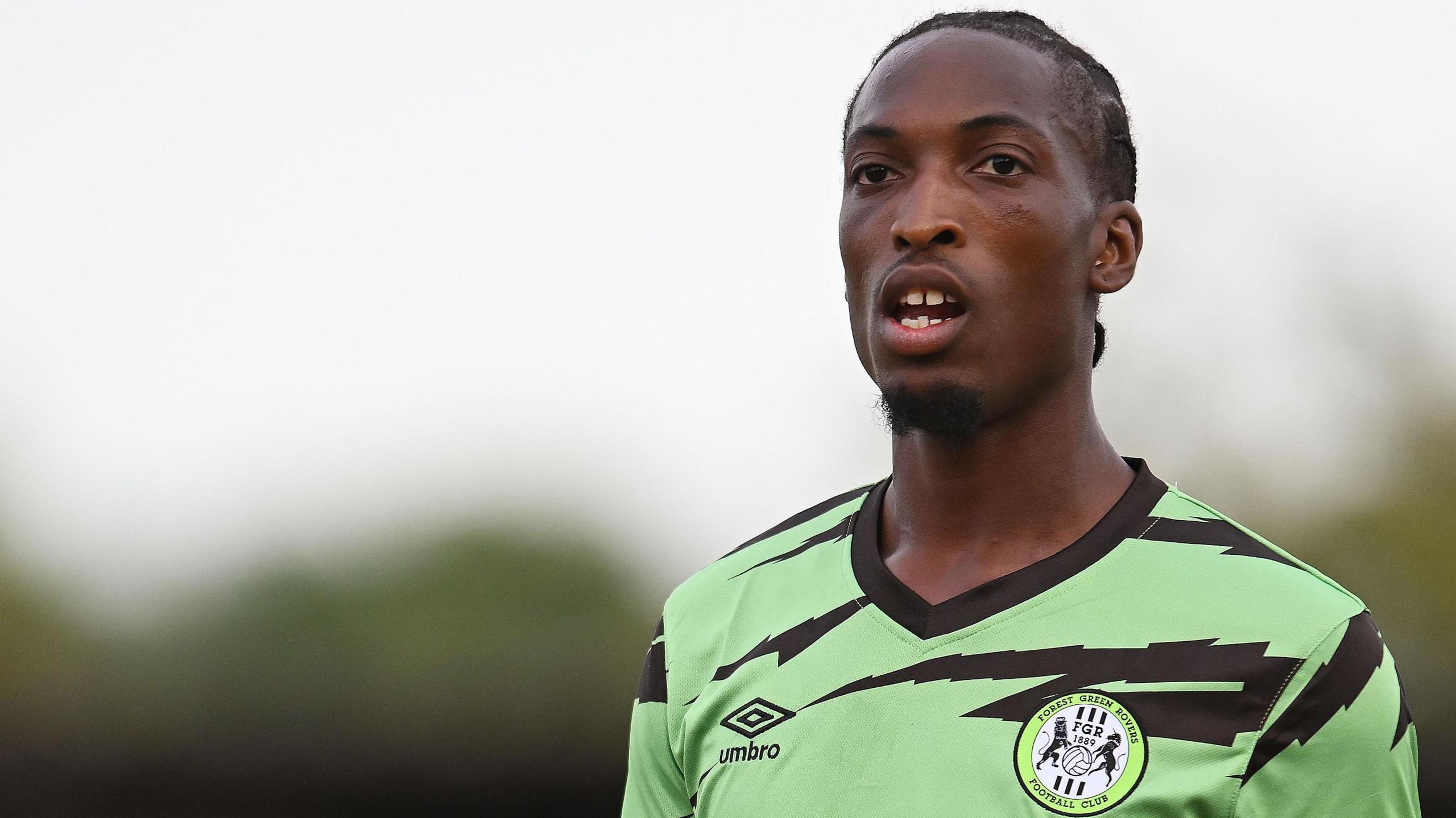 Laurent Mendy in Forest Green's lime green and black kit