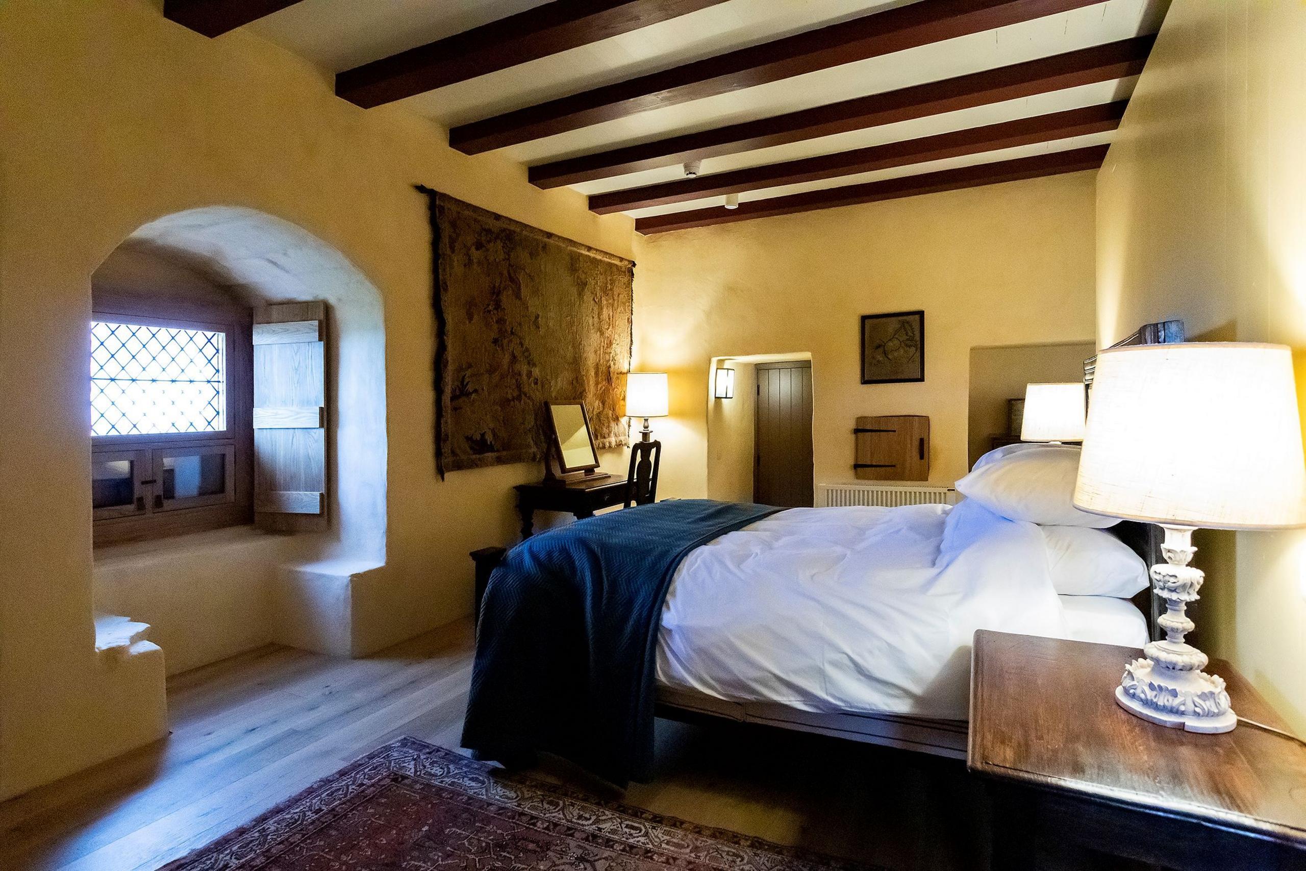 Fairburn Tower - a bedroom with wooden beams on the ceiling