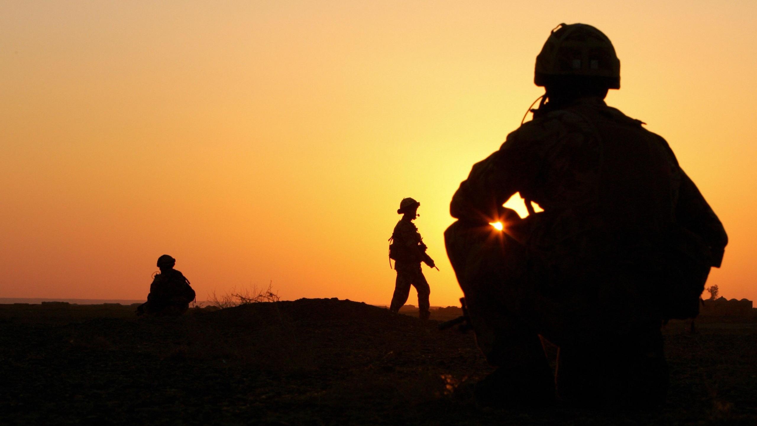 Soldiers are silhouetted at sunset in Afghanistan