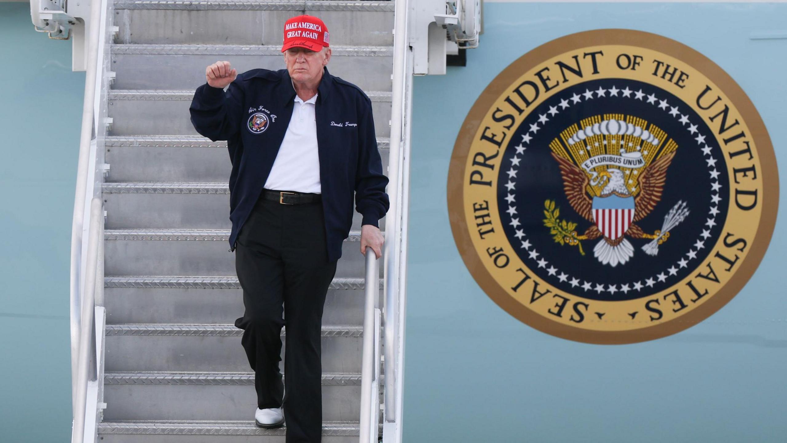 Donald Trump gestures as he departs Air Force One at Miami International Airport on 19 February 2025 in Miami, Florida. 