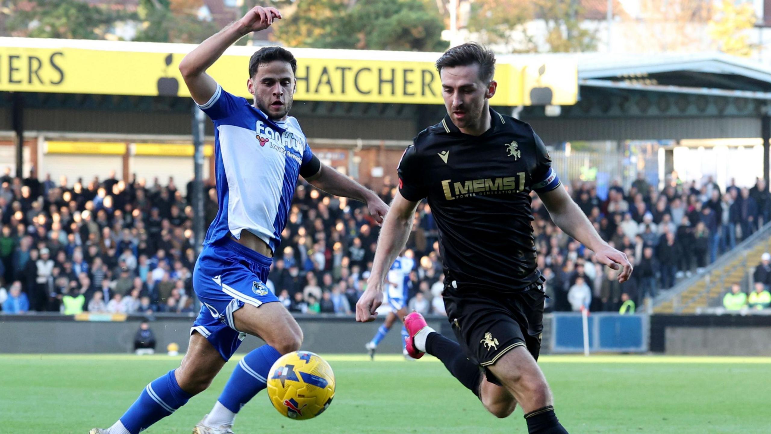 Robbie McKenzie of Gillingham (right) beats Fabrizio Cavegn of Bristol Rovers to the ball