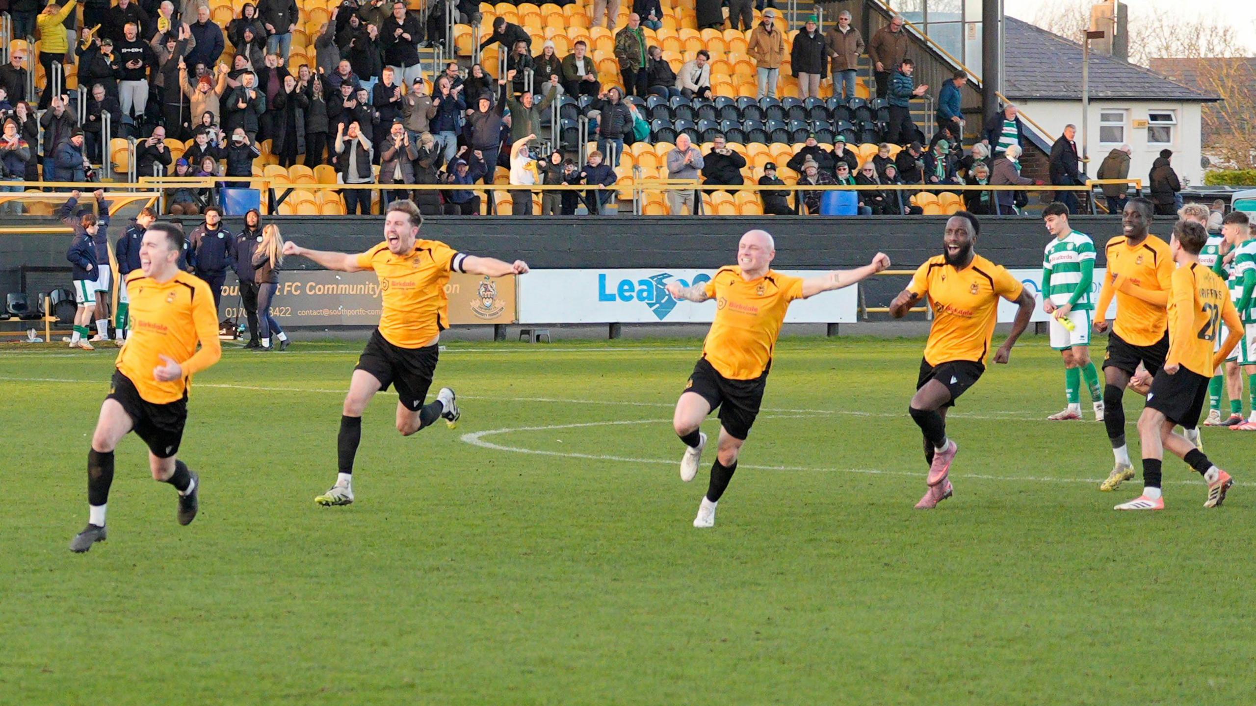 Southport FC's players celebrate as they win the penalty shoot out to progress to the semi-finals during the Isuzu FA Trophy match between Southport and Yeovil Town at Haig Avenue.
