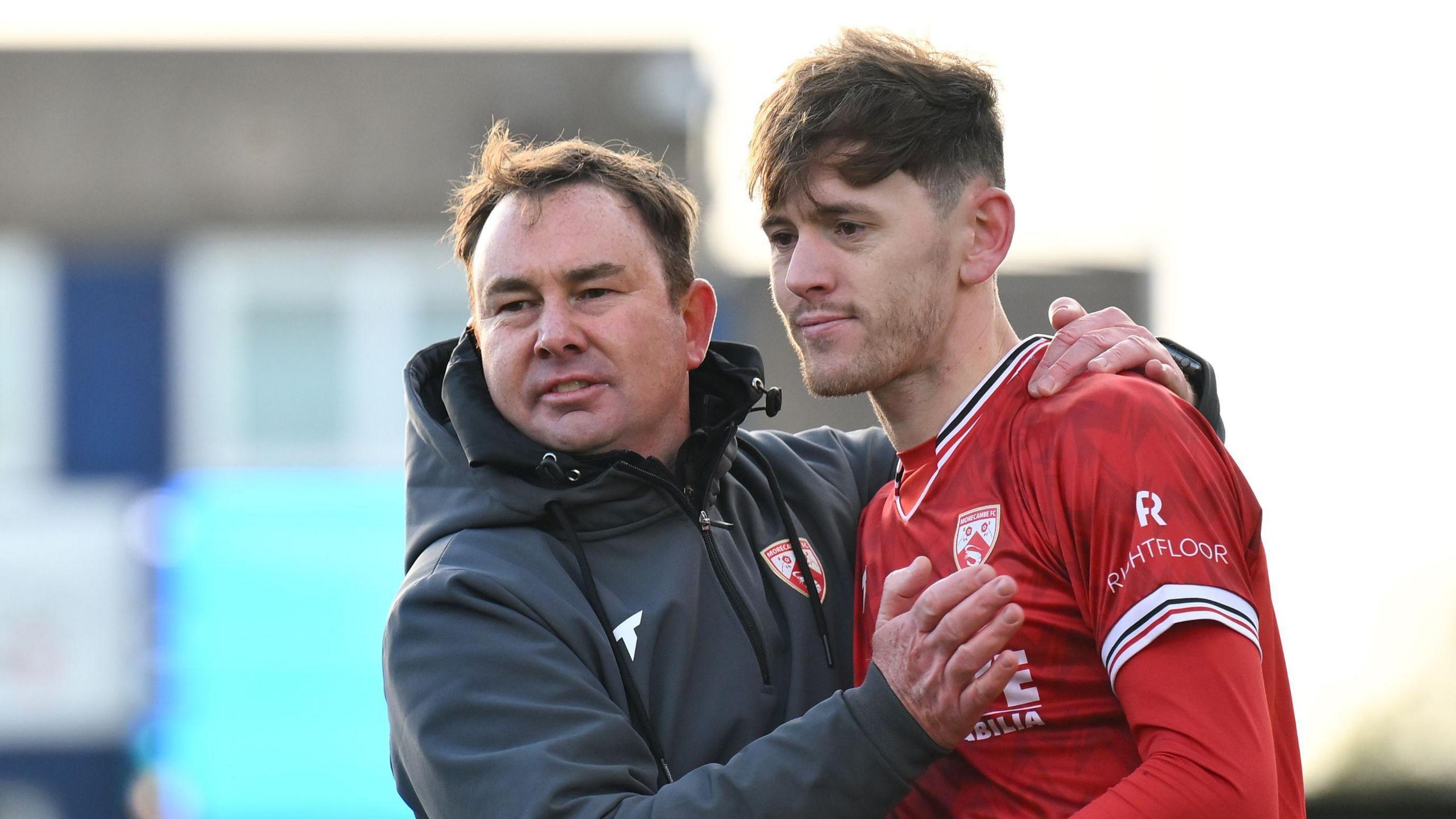 Morecambe manager Derek Adams celebrates his side's 1-0 win at Barrow with goalscorer Ben Tollitt