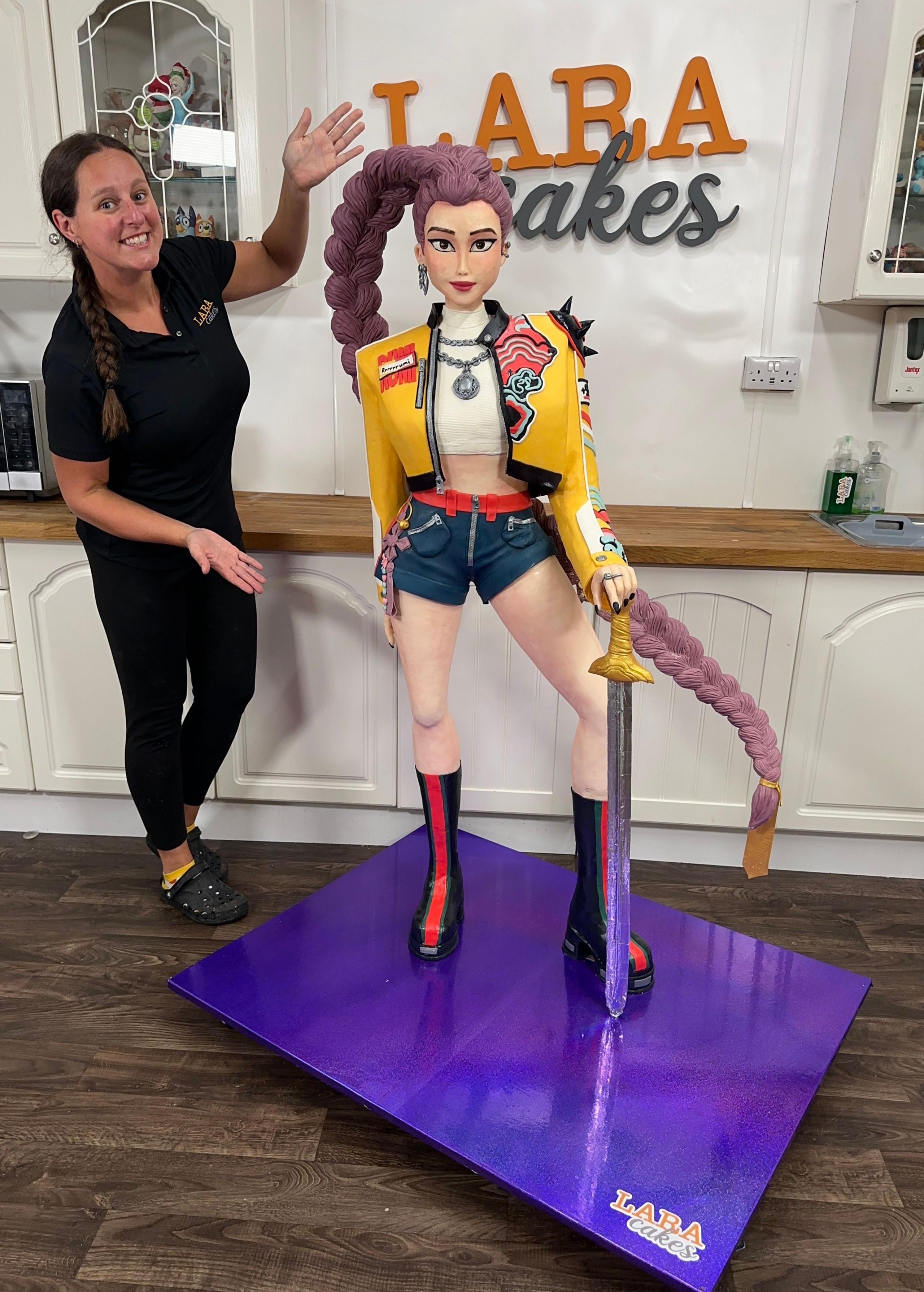 Lara standing with her Rumi cake.