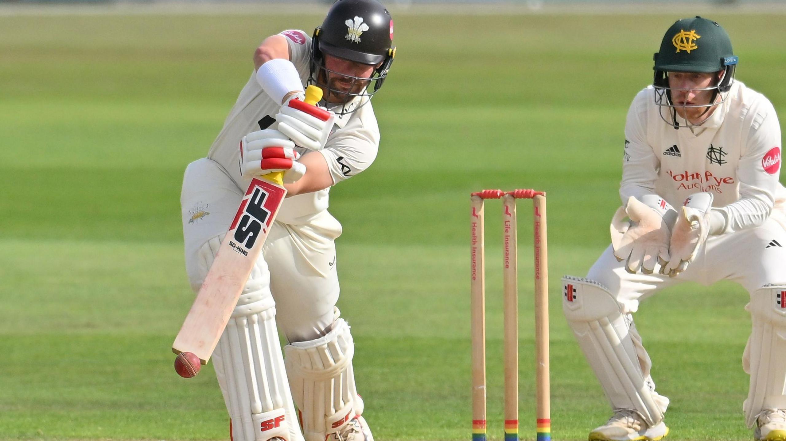 Surrey skipper Rory Burns tries to steer on the off side at Trent Bridge, watched by Notts wicketkeeper Kyle Verreynne