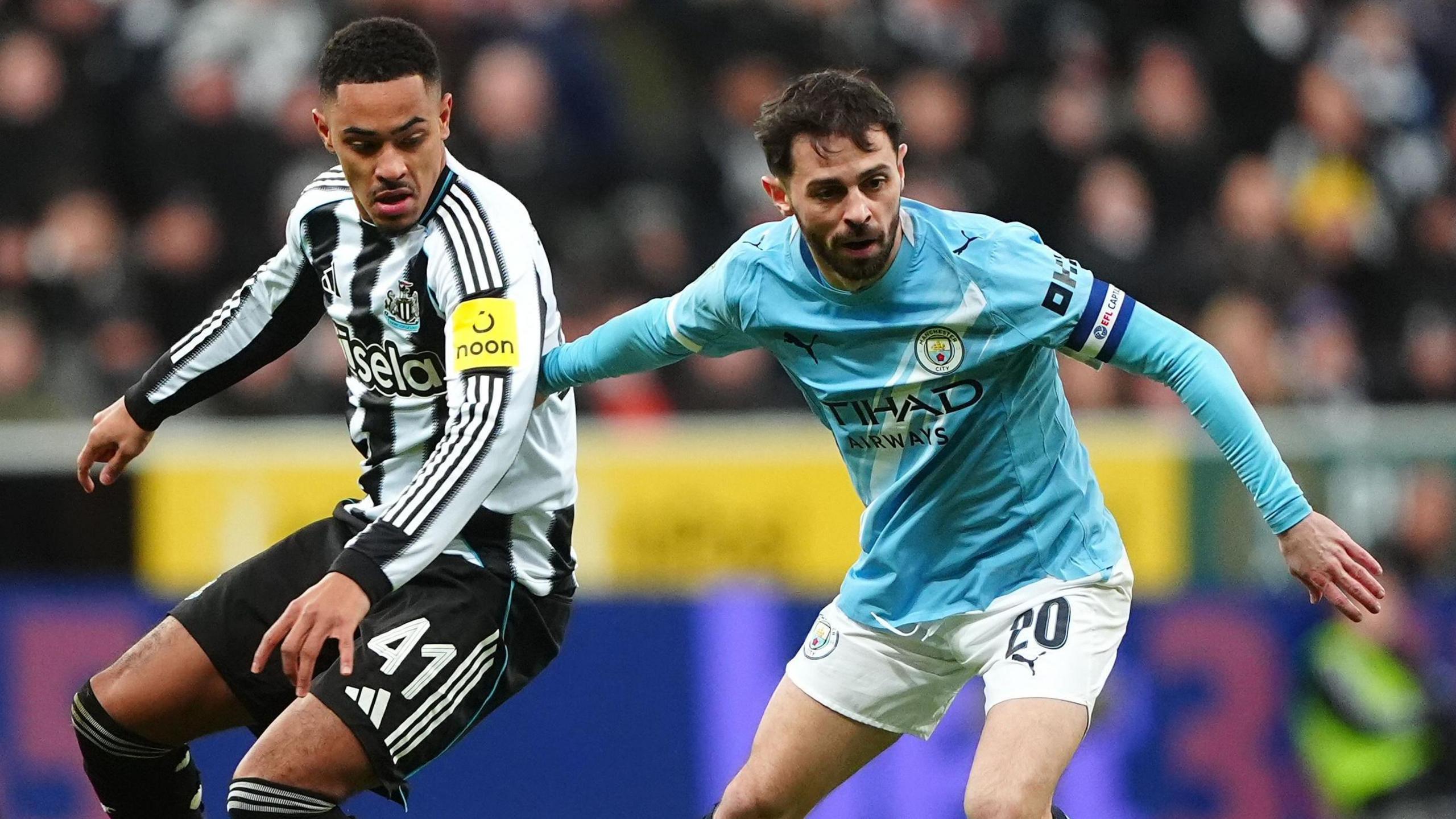 Jacob Ramsey and Bernardo Silva battle for the ball