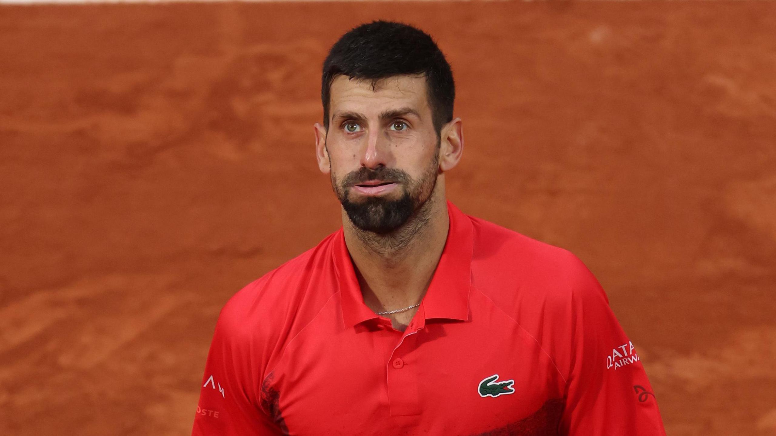 Novak Djokovic puffs out his cheeks during his French Open semi-final defeat by Jannik Sinner