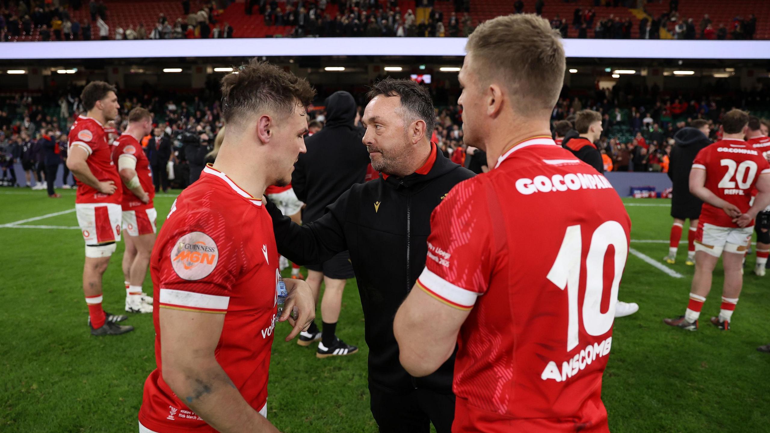 Interim head coach Matt Sherratt consoles Wales half-backs Tomos Williams and Gareth Anscombe (right)