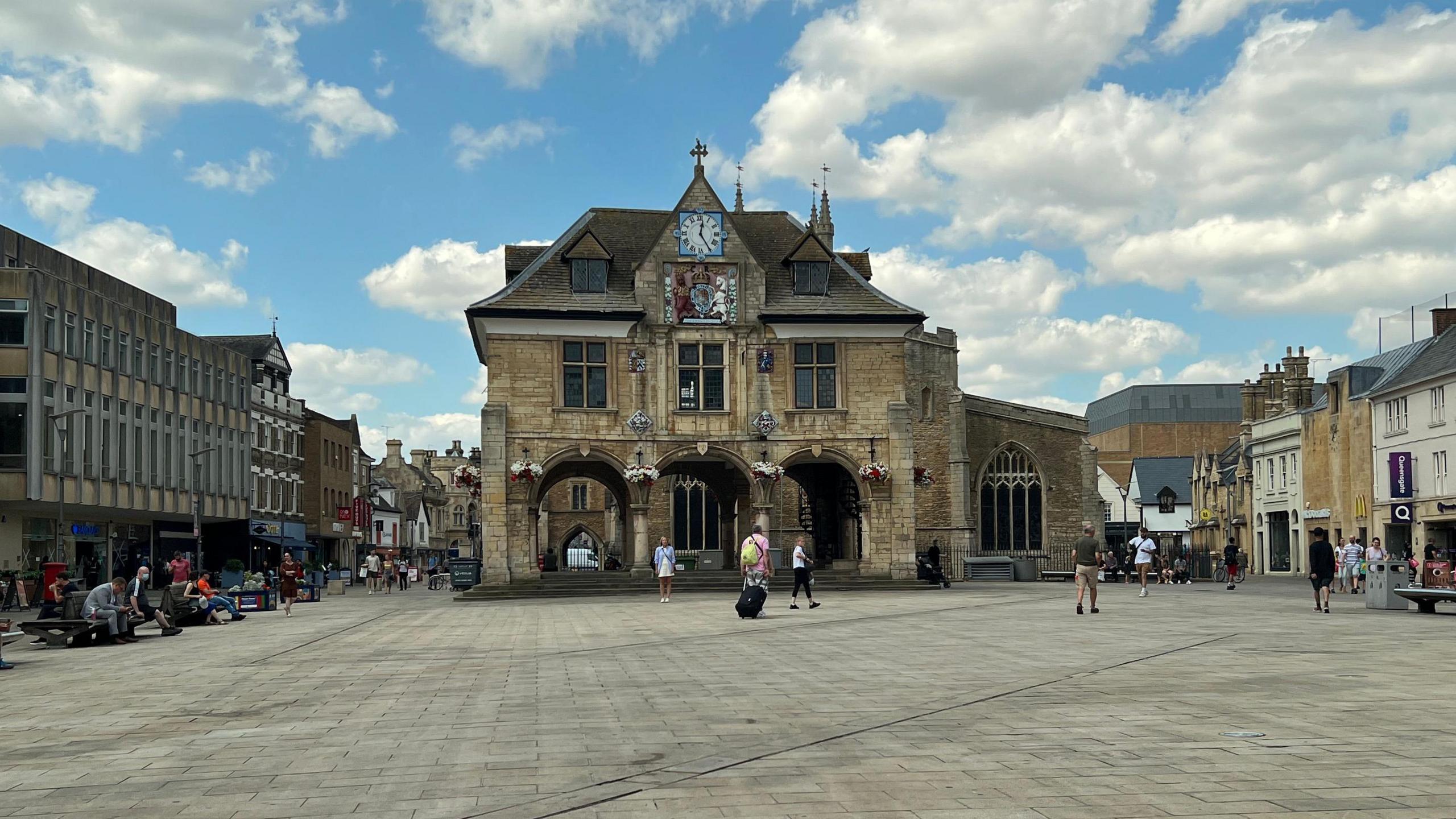 Peterborough's Guildhall with people walking by