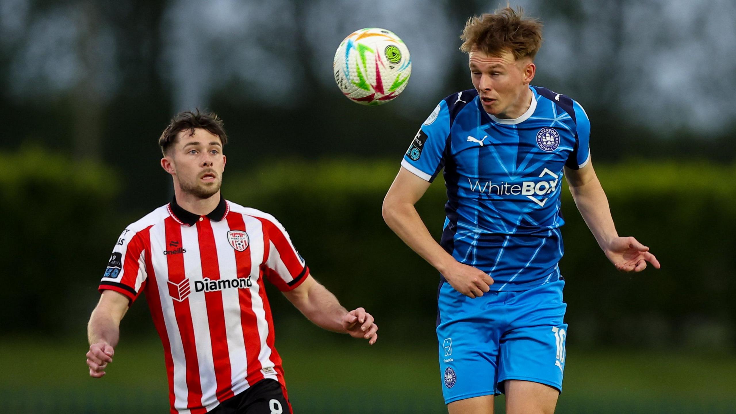 Adam O'Reilly and Conan Noonan battle for the ball 