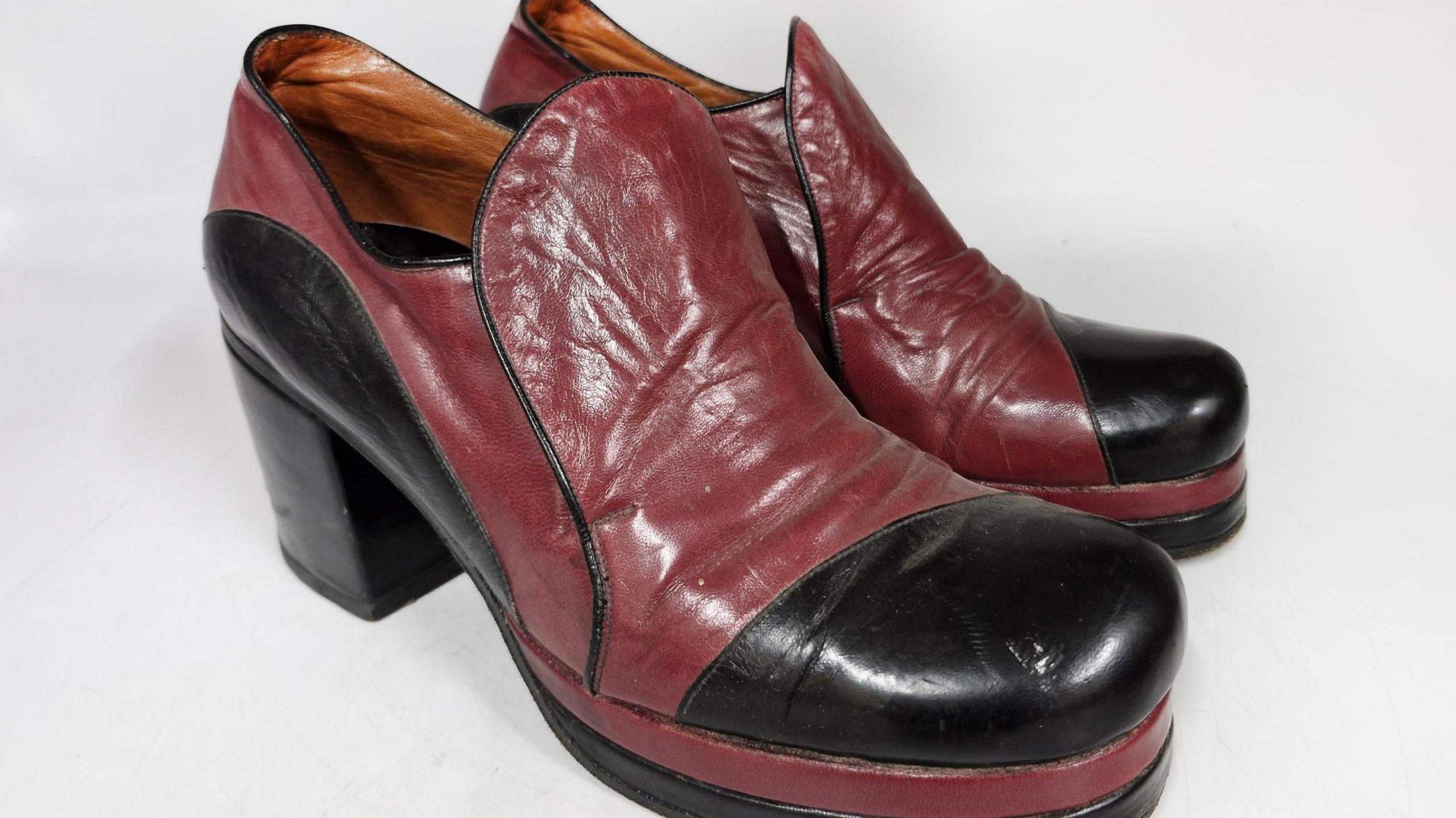 A pair of leather platform boots in red and black