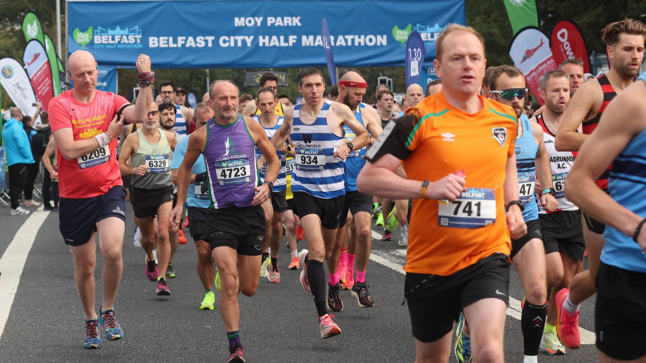 Runners setting off at Ormeau embankment in a variety of team colours and vests displaying various charities