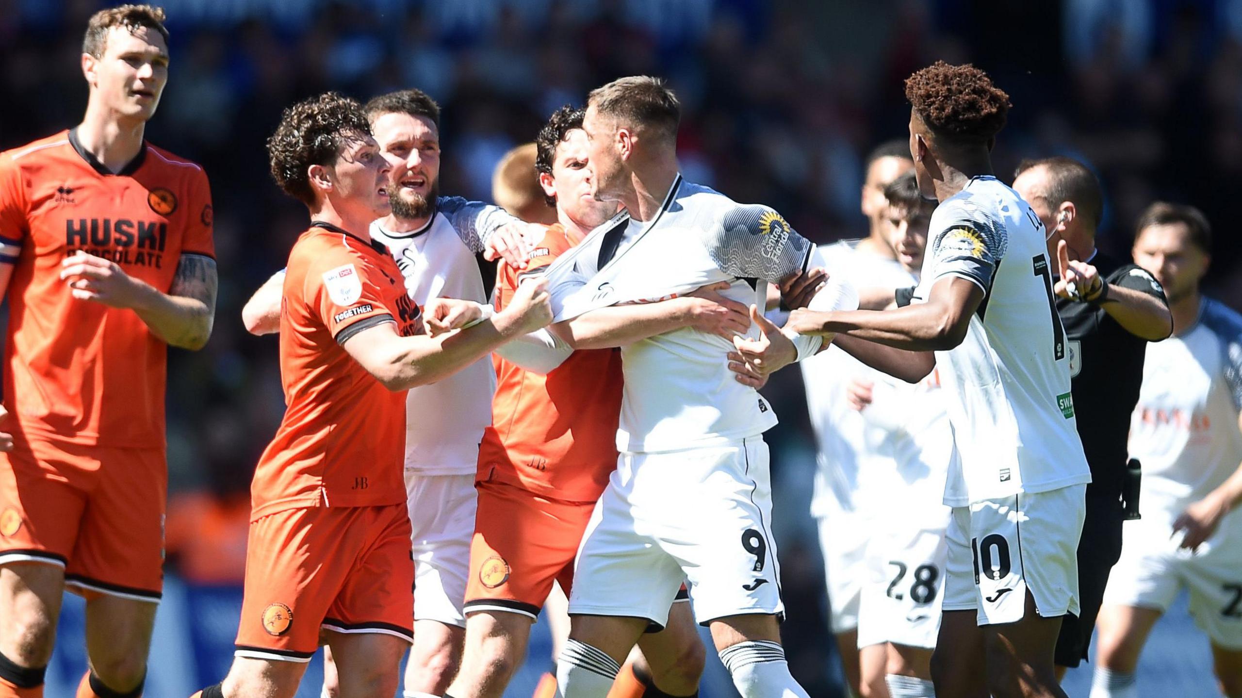 Swansea's Jerry Yates tangles with Millwall's players