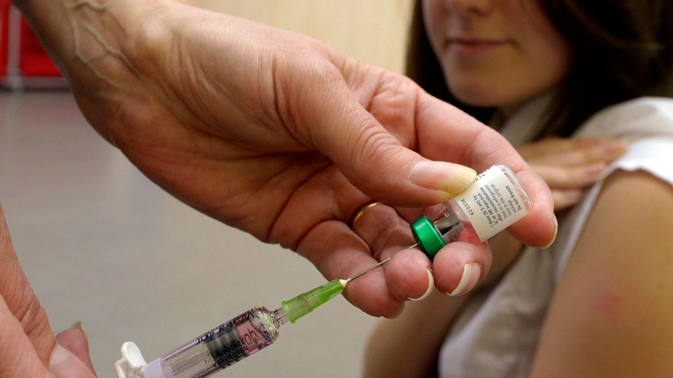 Teenager having  a jab