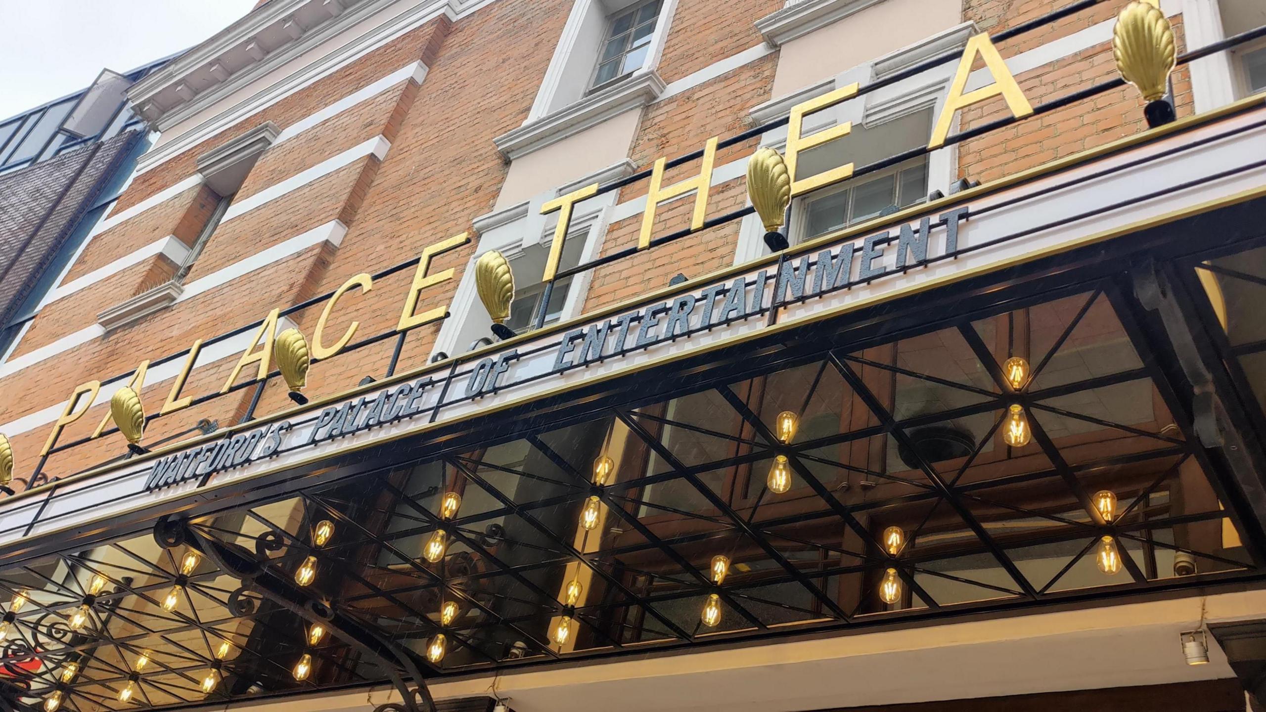 Exterior shot of the signage of the Watford Palace Theatre, with the wording 'Watford's palace of entertainment' underneath.