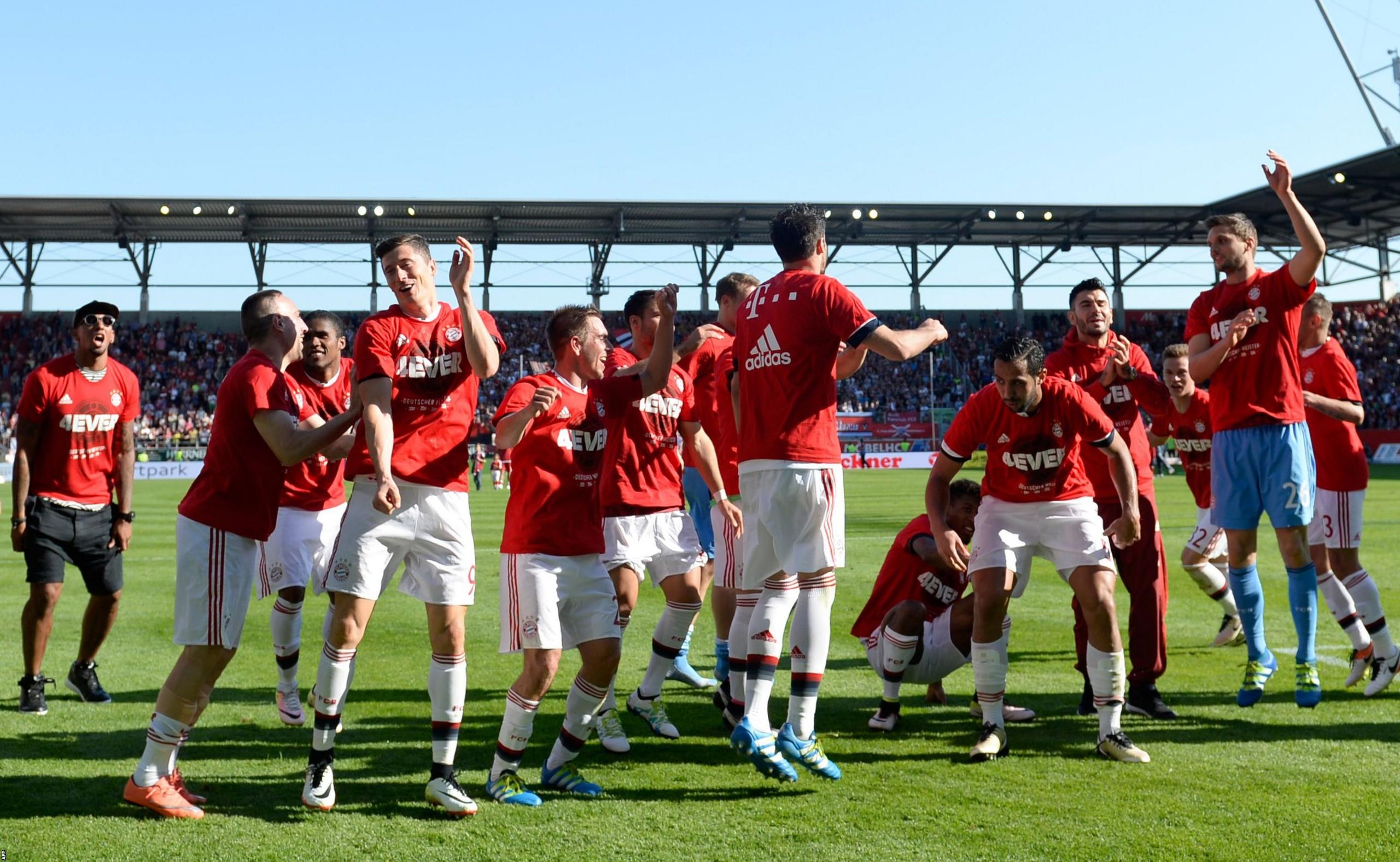 Bayern Munich players celebrate winning the Bundesliga for a record fourth successive season