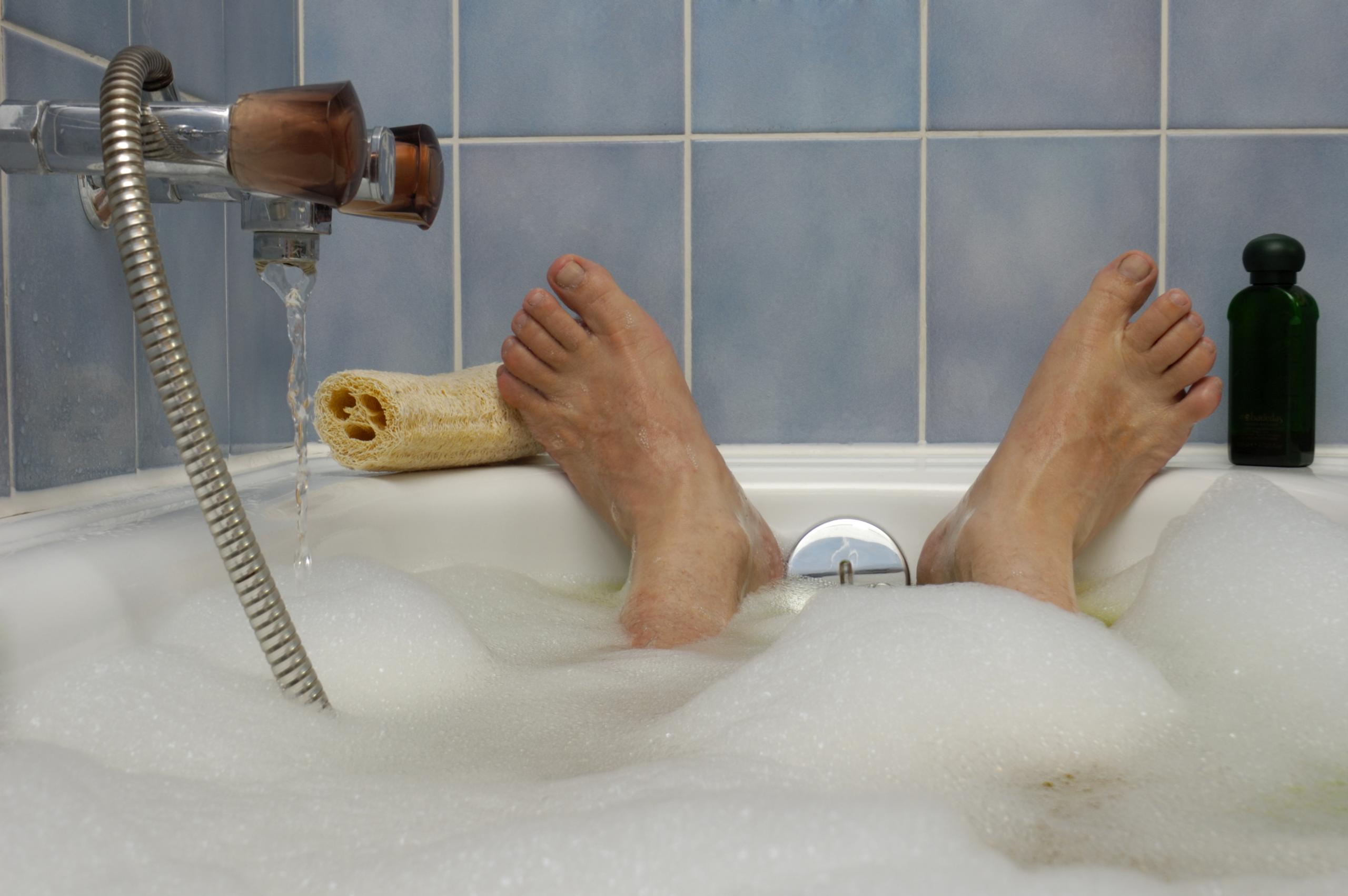 Feet sticking up at the end of the bath