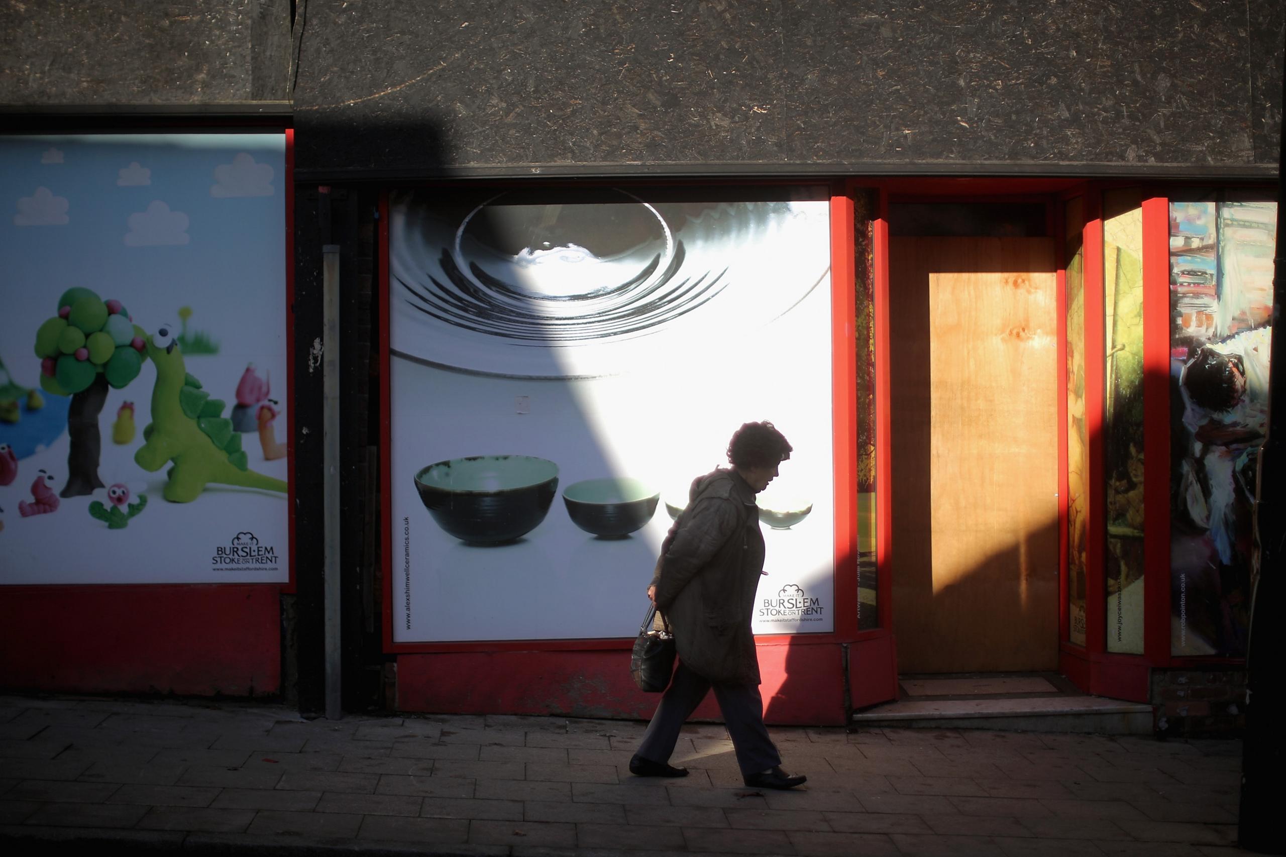 A woMan walks past empty shops in Burslem on February 4, 2015 in Burslem, Stoke-on-Trent