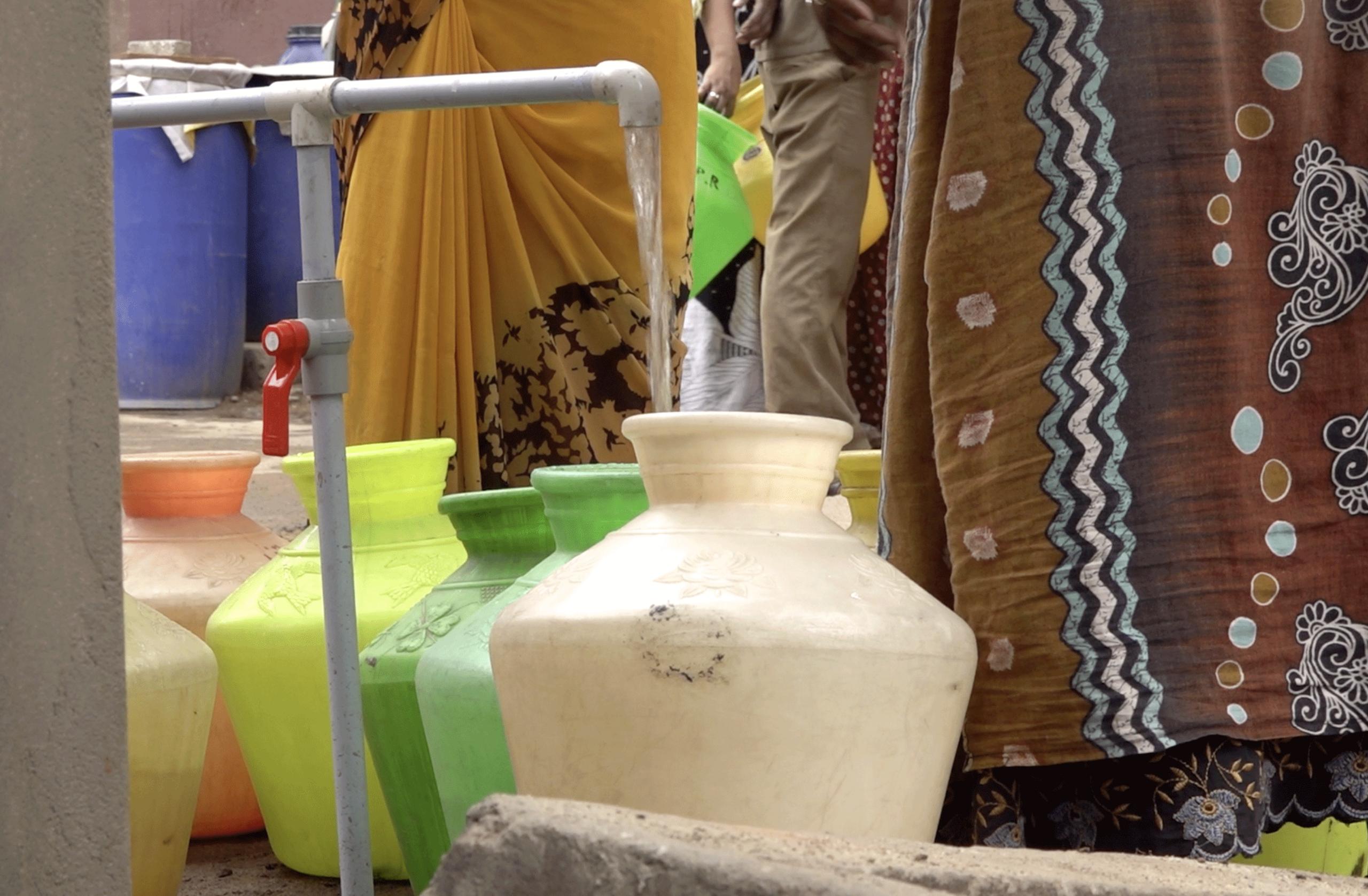 Women collecting water from a sump in Chennai