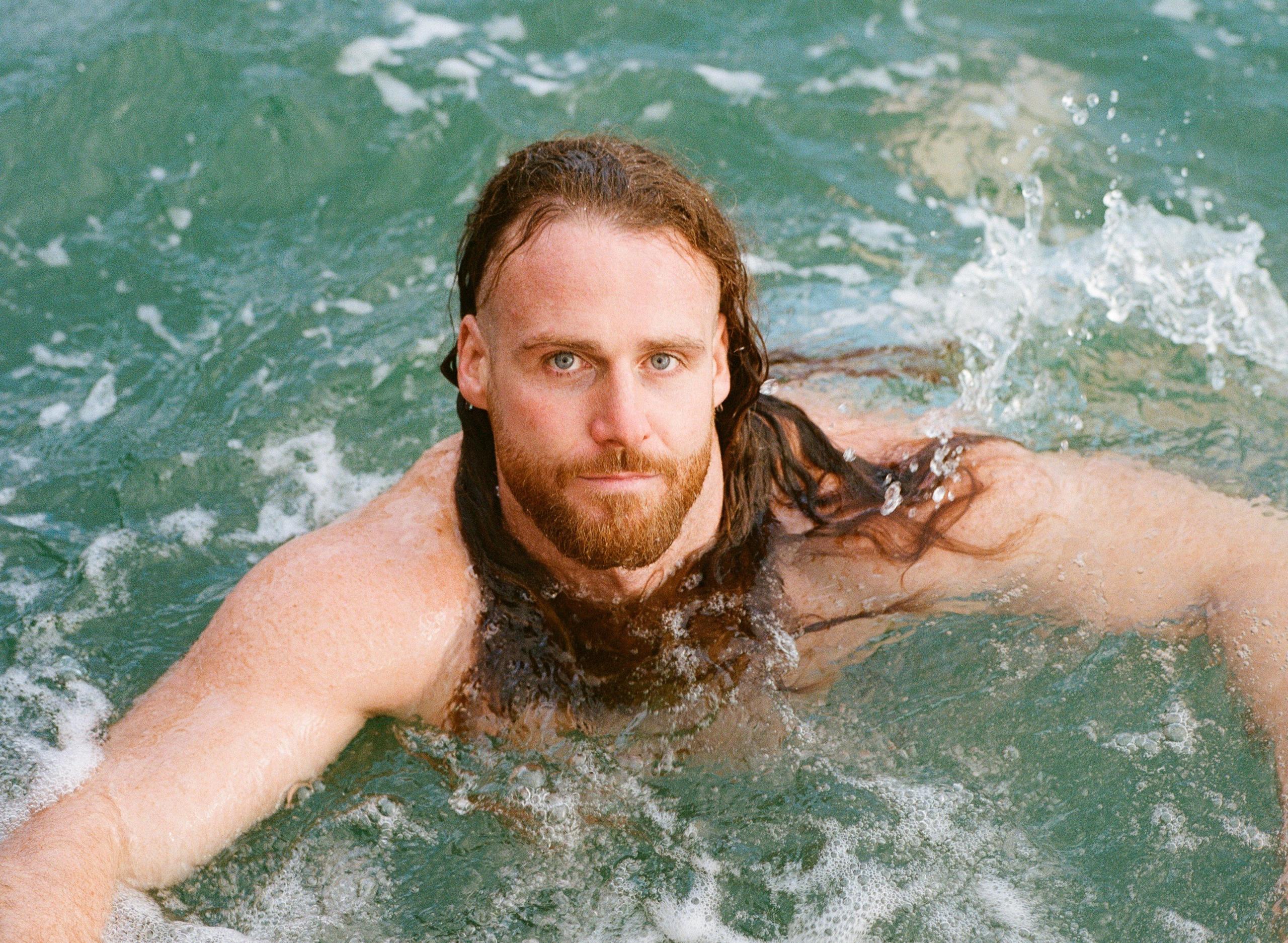 Anthony Mullally swims in the sea off the Cornish coast