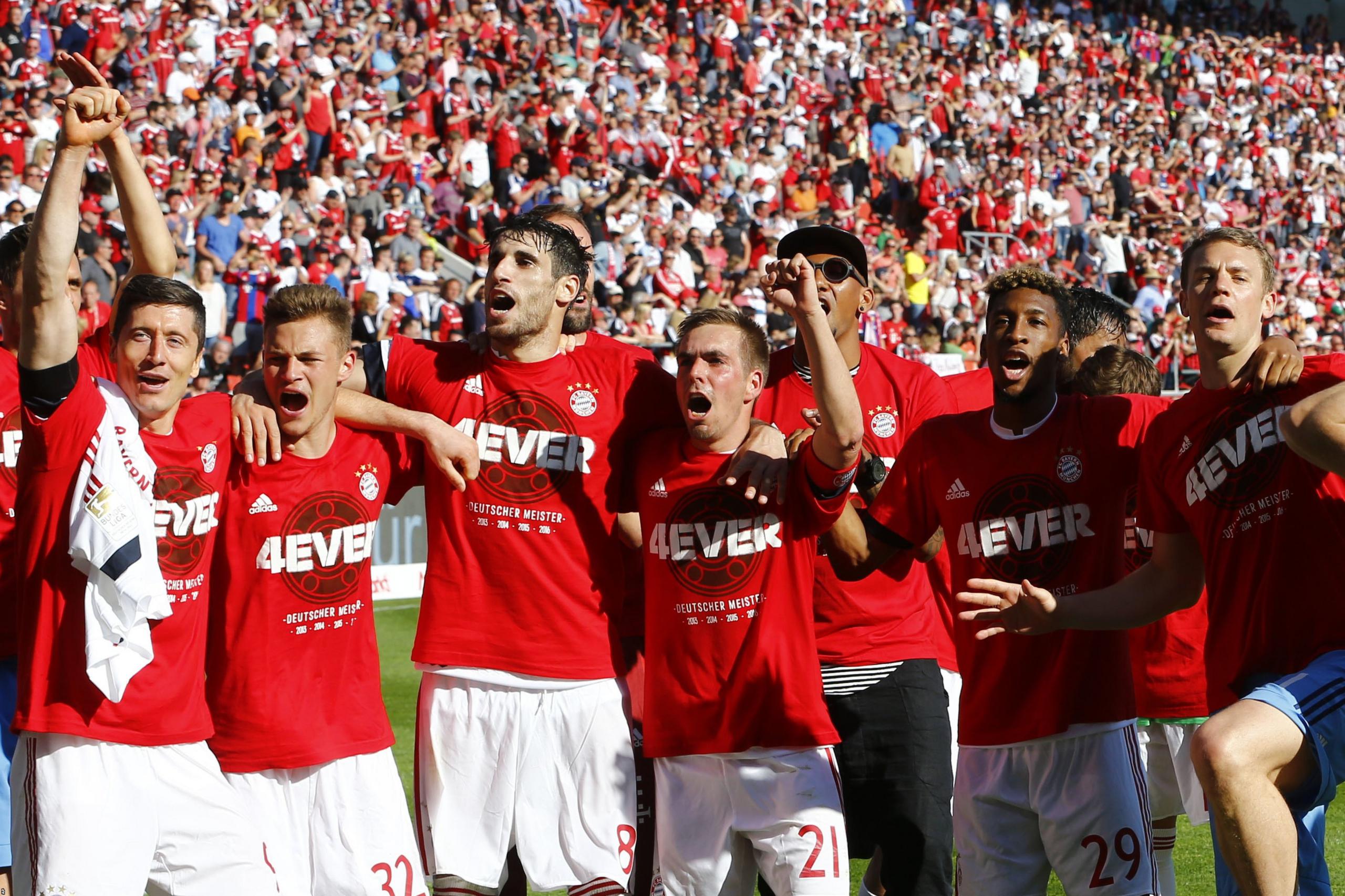 Bayern Munich's players celebrate after securing a record fourth straight Bundesliga title