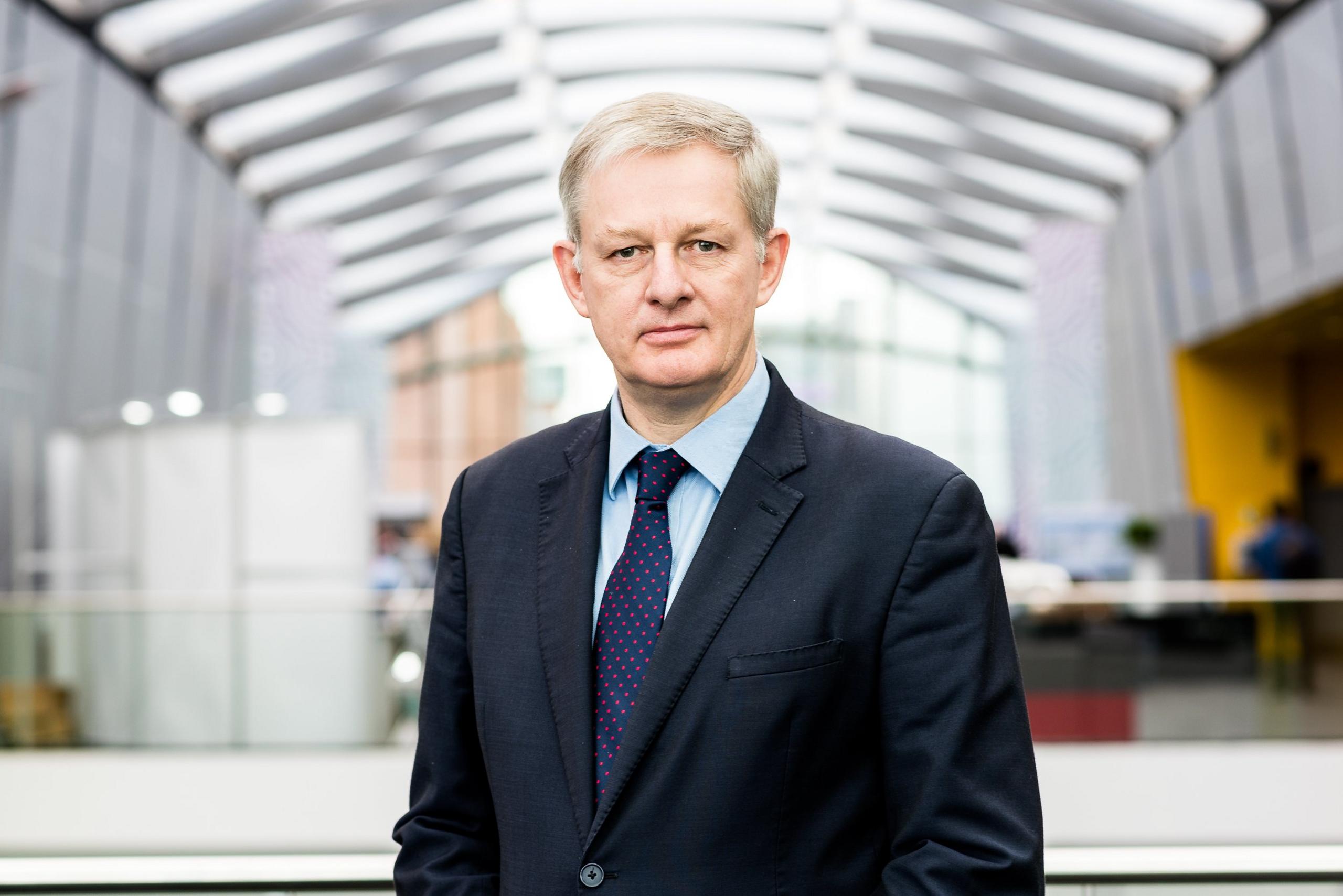 A picture of Dr William Ramsden, who is wearing a suit and tie.