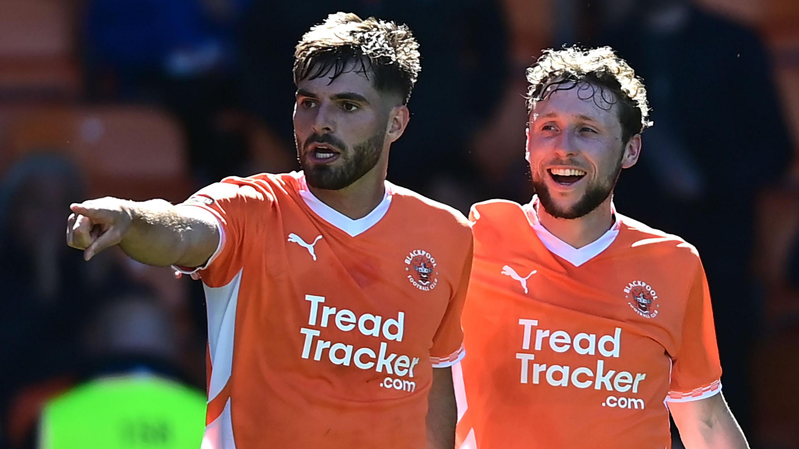 Blackpool's Tom Bloxham celebrates scoring his side's first goal with team-mate Matthew Pennington