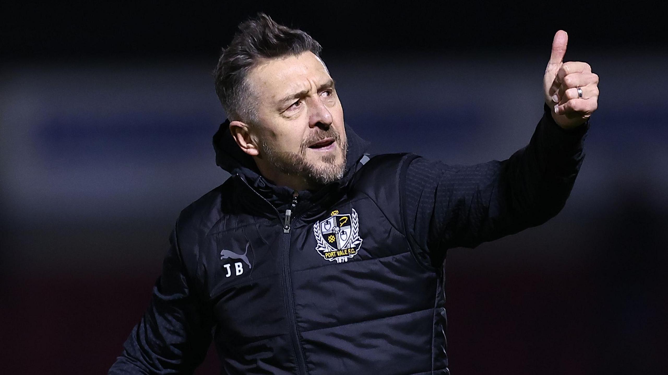 Jon Brady gives a thumbs up sing to the Port Vale fans after their win at Northampton