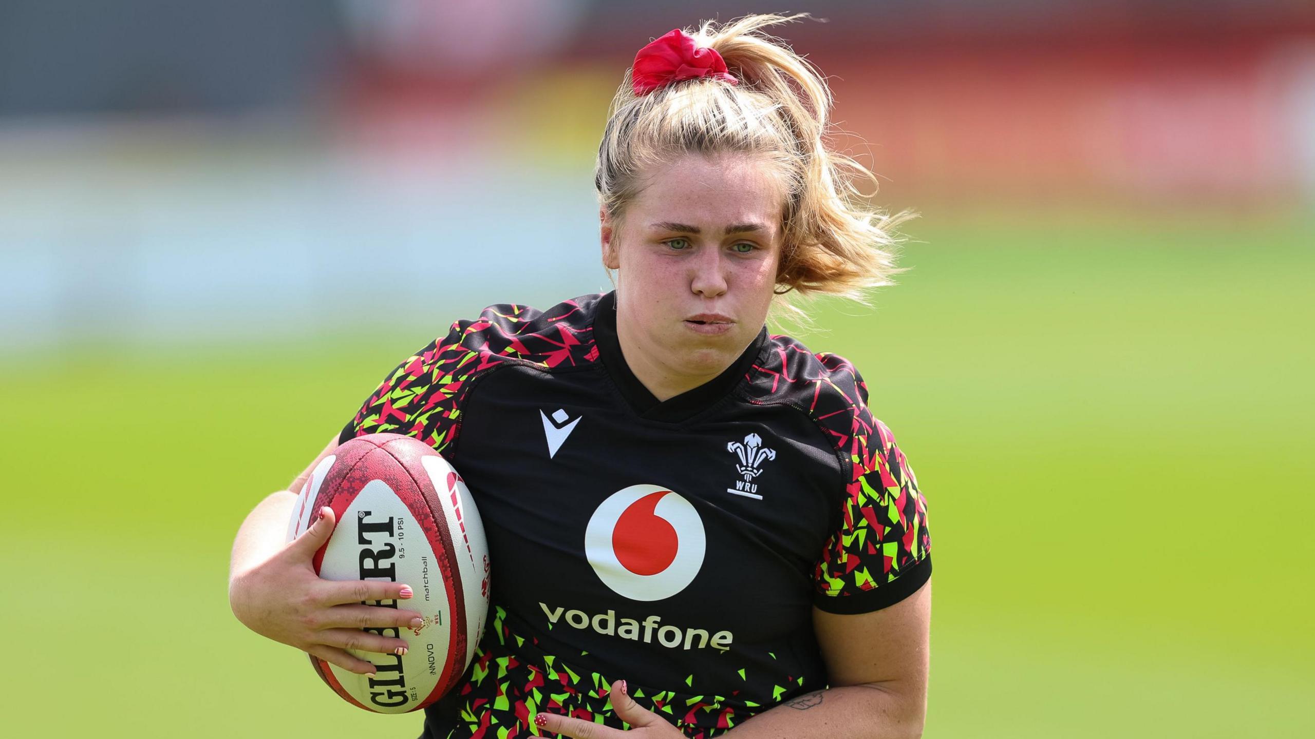 Alex Callender carries the ball for Wales in training