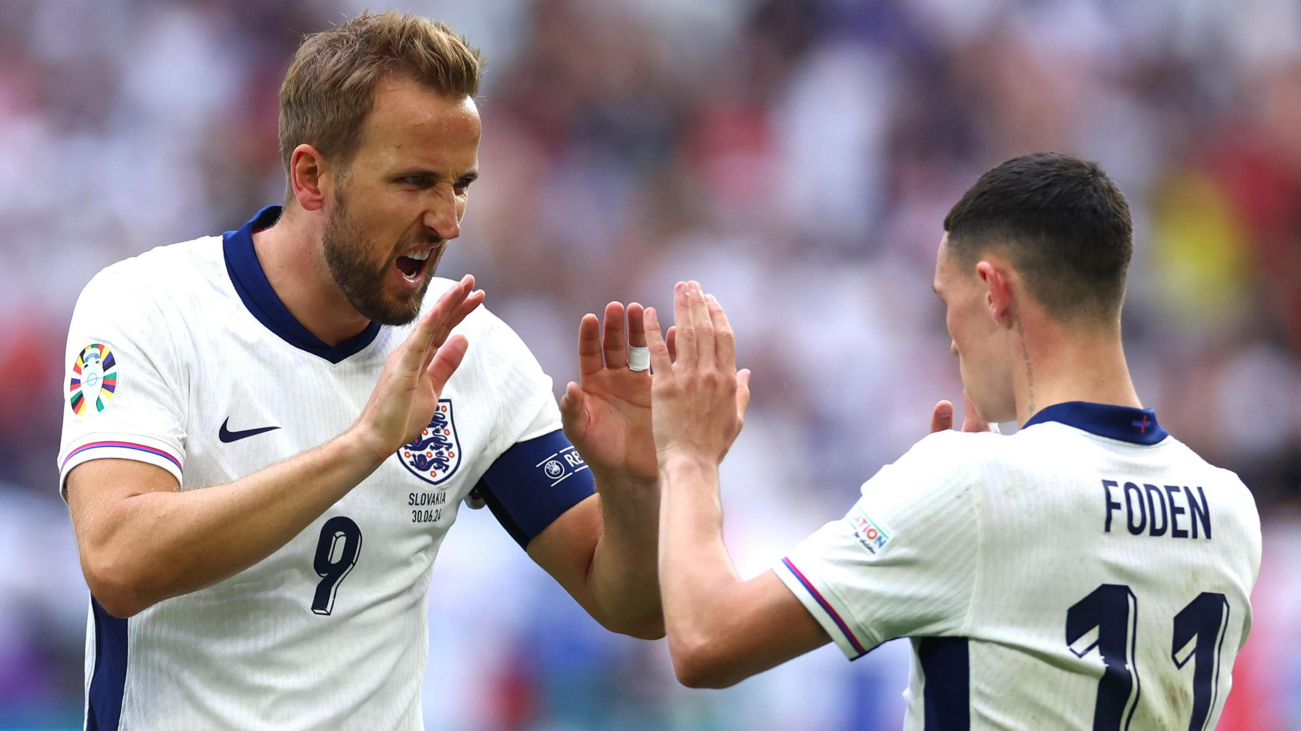 England captain Harry Kane (left) high fives team-mate Phil Foden