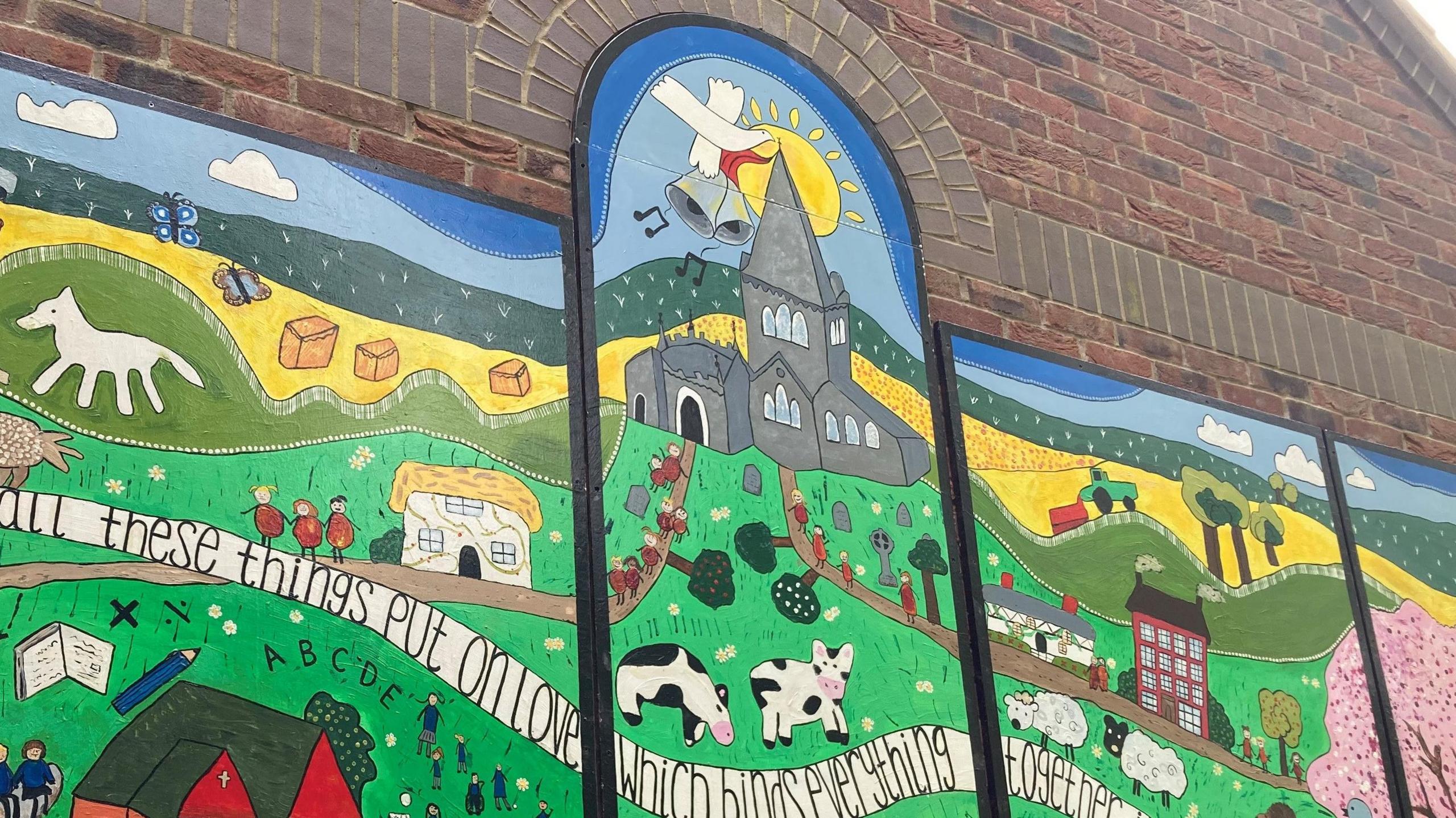 The focal point of the mural is a church spire, with the sun peeking out from behind it