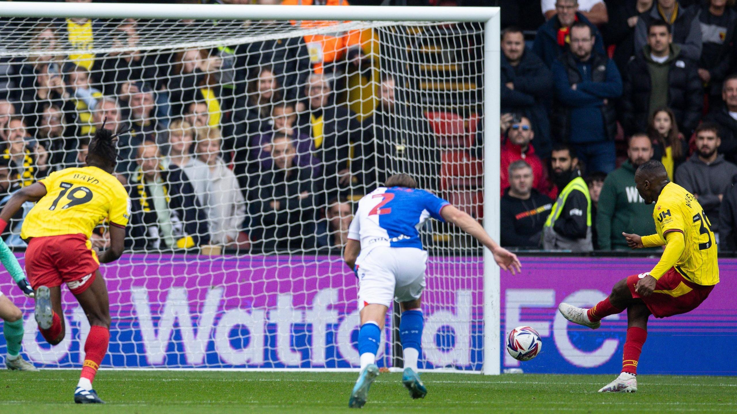 Edo Kayembe slots his penalty into the side of the goal with his left foot