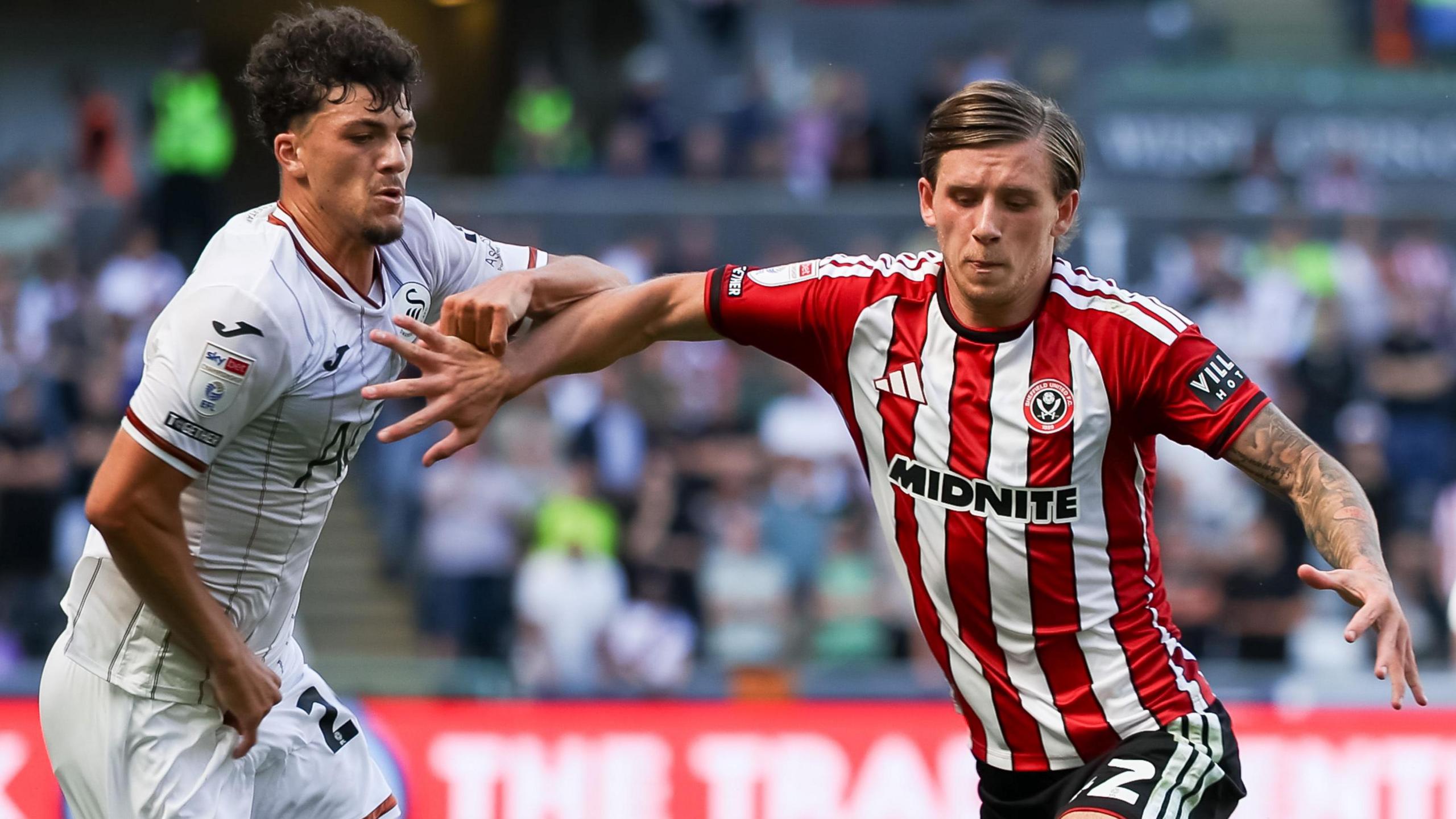 Filip Lissah of Swansea City and Sydie Peck of Sheffield United battle for the ball