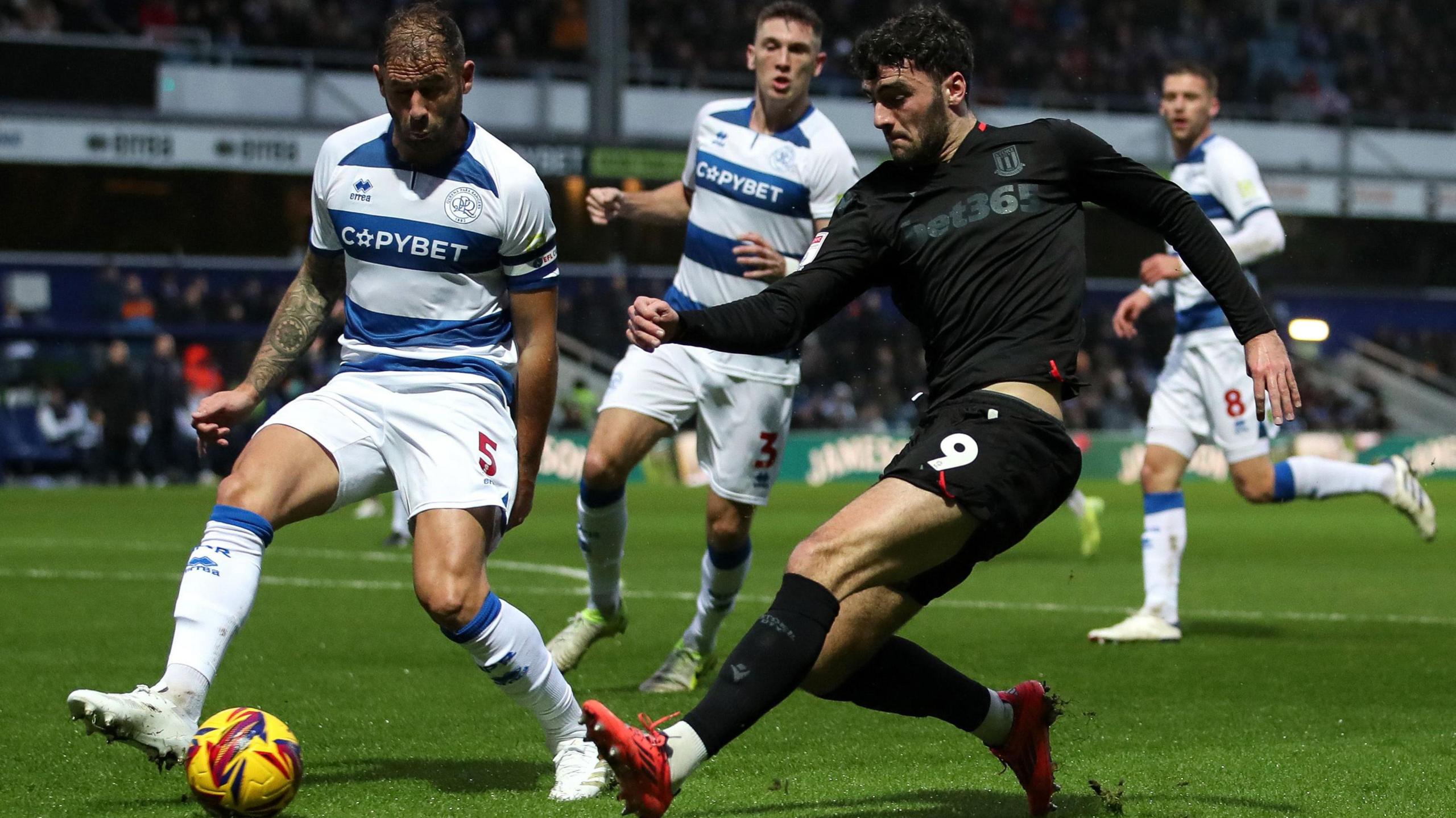 Stoke City's Tom Cannon battles for the ball against QPR's' Steve Cook during the Championship match at Loftus Road 